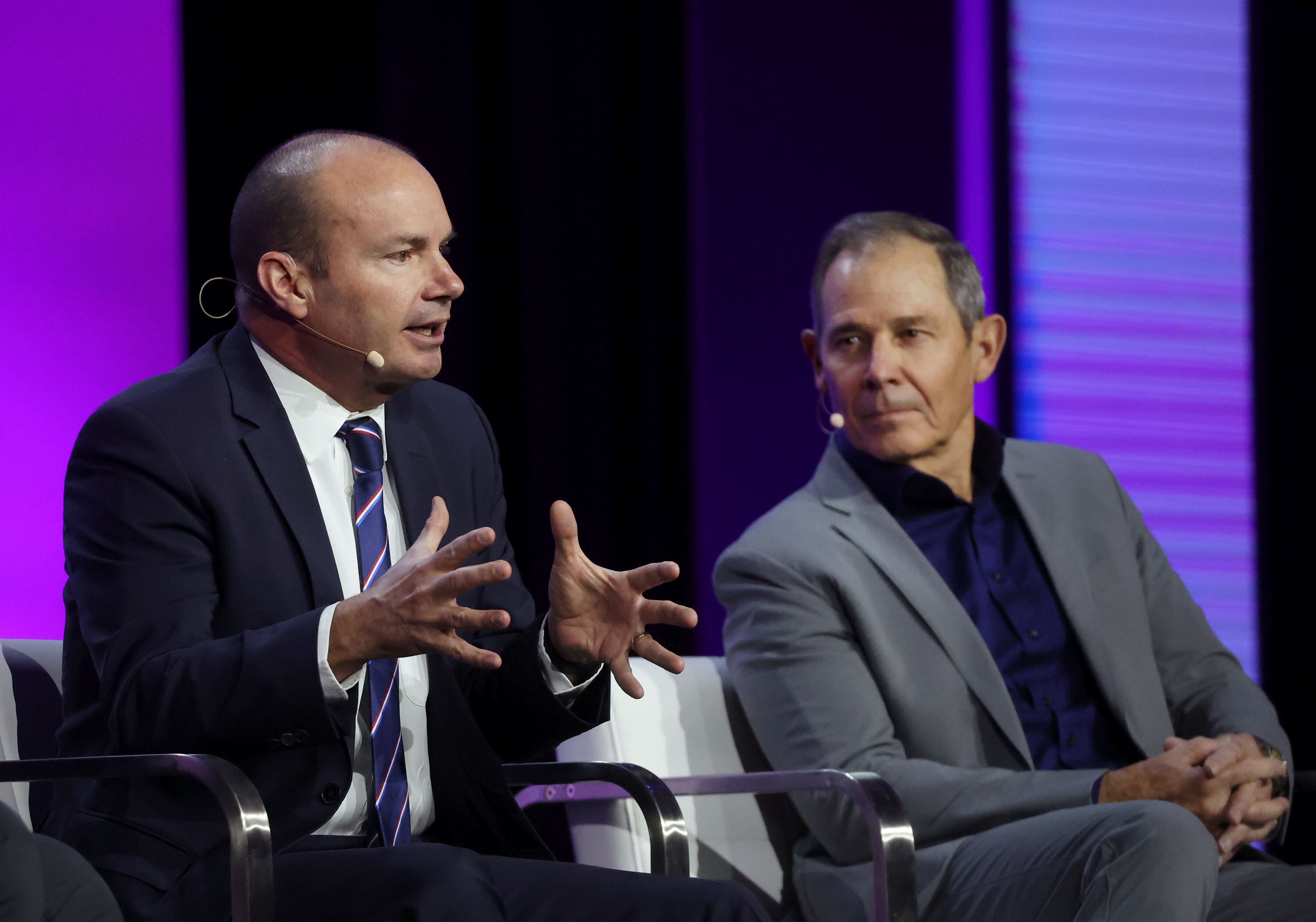 Sen. Mike Lee, R-Utah, and Rep. John Curtis, R-Utah, speak at the Salt Palace Convention Center in Salt Lake City on Friday. The two told a room of cryptocurrency developers on Friday that digital money represents a revolution in financial freedom.