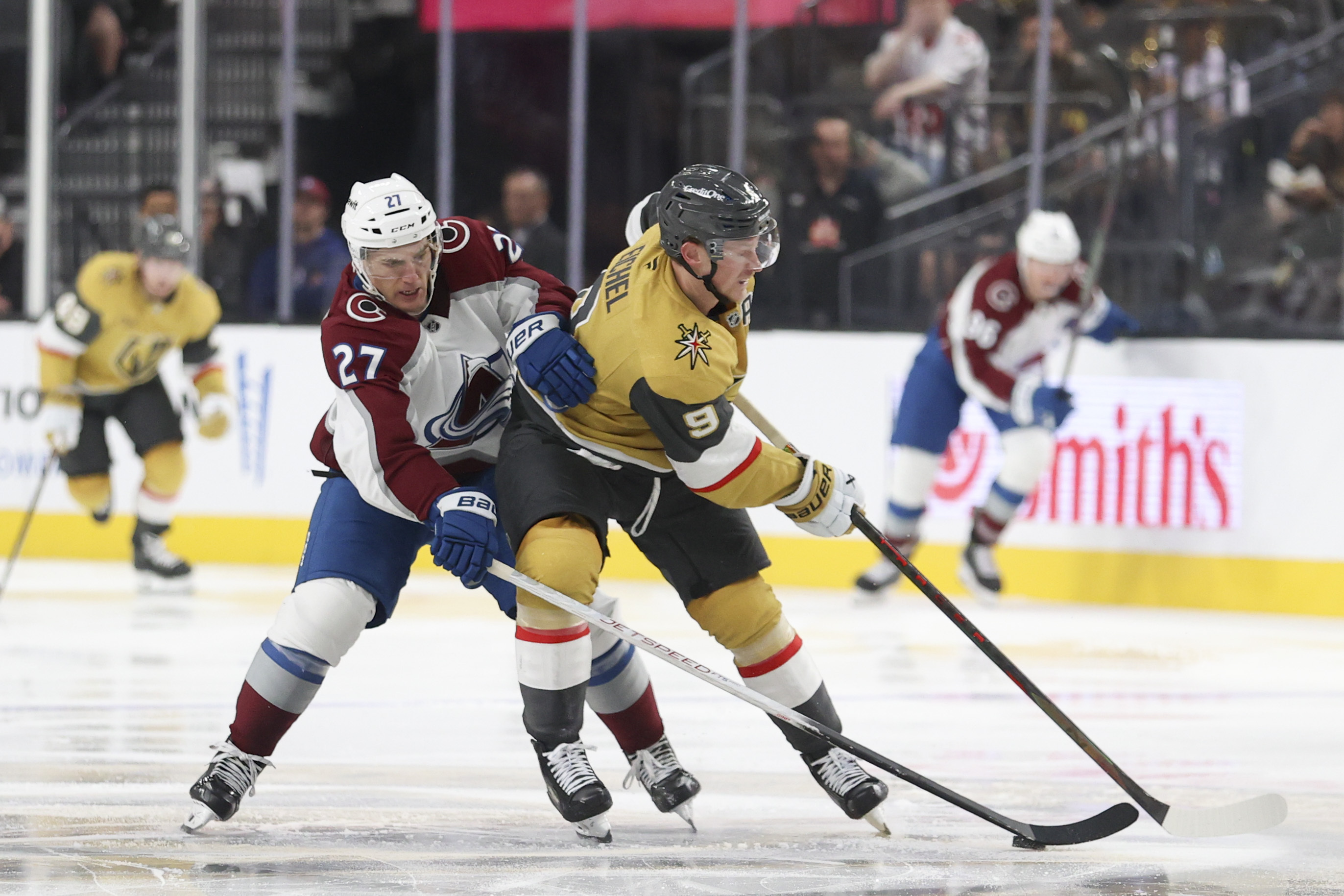 Colorado Avalanche left wing Jonathan Drouin (27) attempts to steal the puck from Vegas Golden Knights center Jack Eichel (9) during the second period of an NHL hockey game Wednesday, Oct. 9, 2024, in Las Vegas.