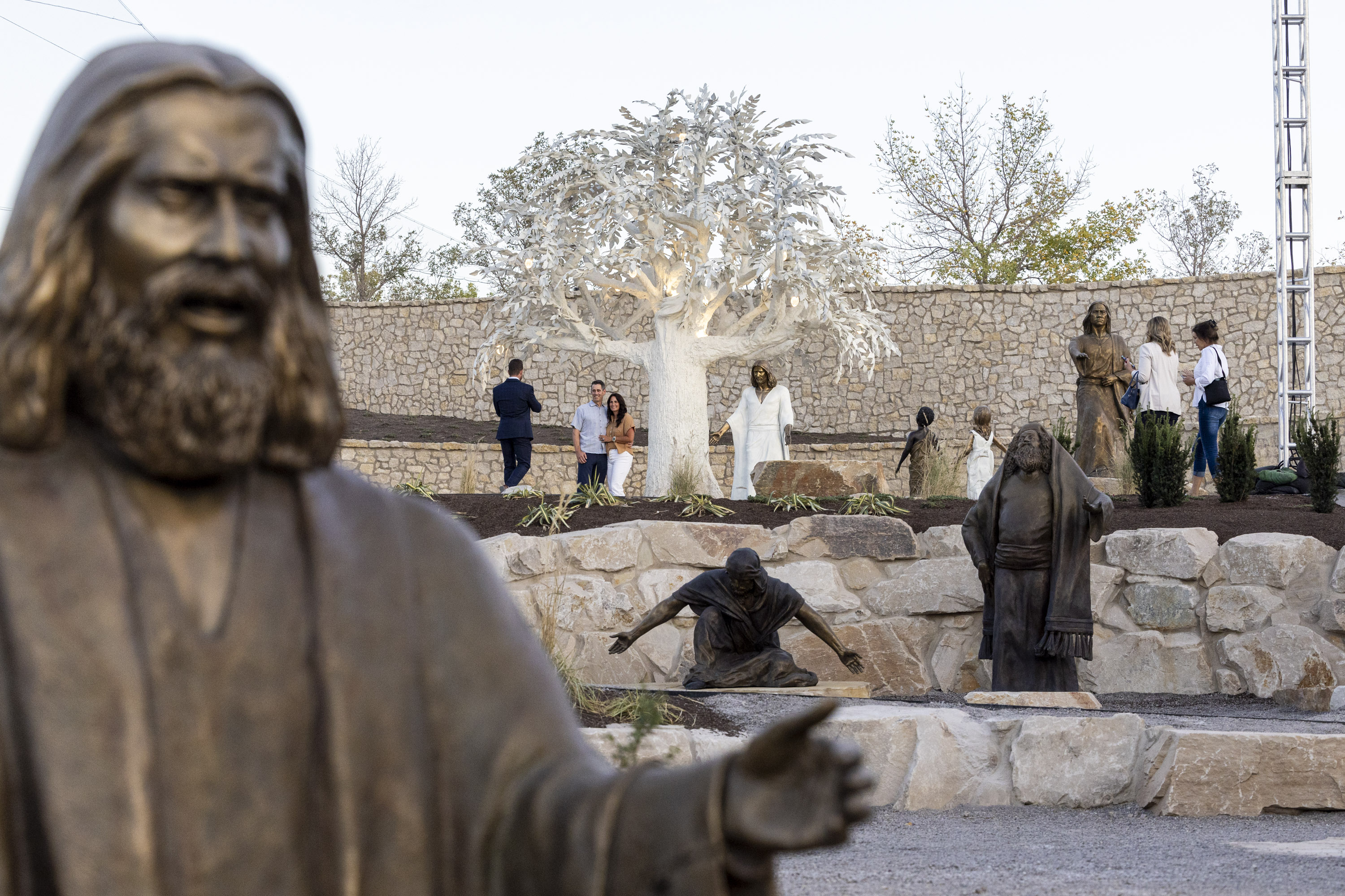 Bronze statues depict scenes from Lehi’s vision in the Book of Mormon as Vance and Amy Huntley, both of Centerville, have their picture taken at the Tree of Life sculpture garden at the Ashton Gardens at Thanksgiving Point in Lehi on Wednesday.