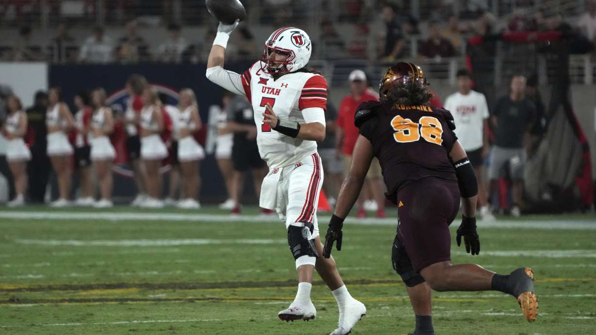 Utah quarterback Cameron Risingthrows in front of Arizona State defensive lineman Jacob Rich Kongaika (98) in the second half during an NCAA college football game, Friday, Oct. 11, 2024, in Tempe, Ariz.