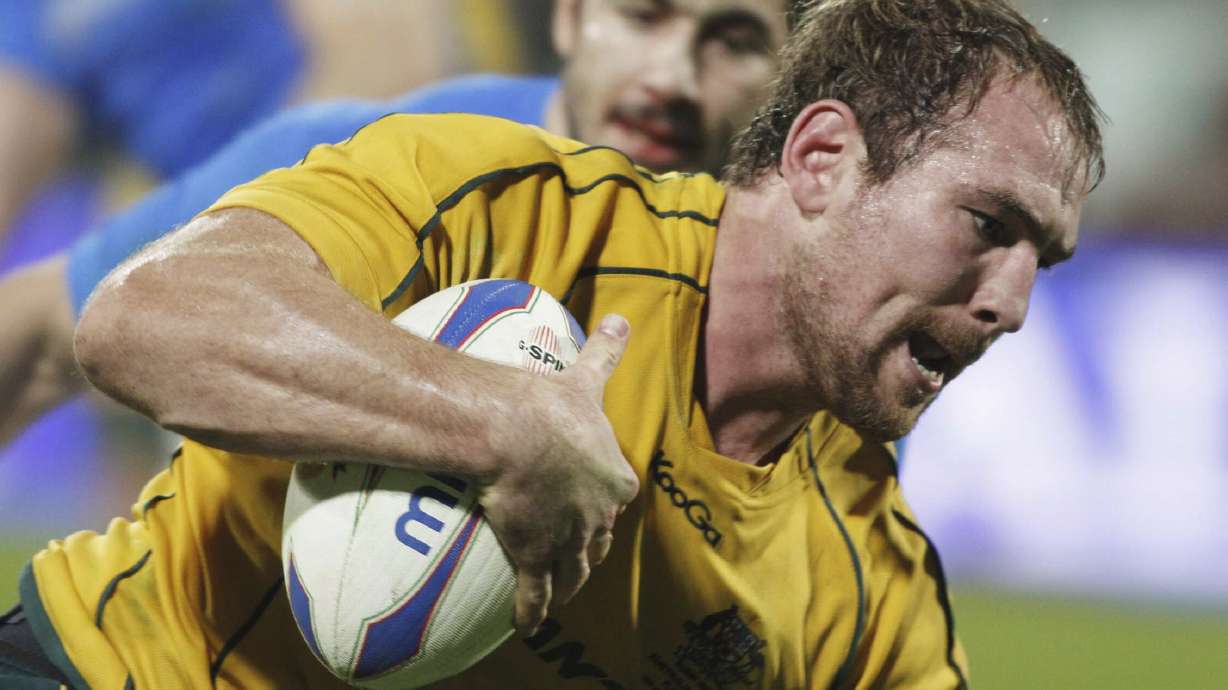 FILE - Australia's Rocky Elsom scores during the international rugby union match between Italy and Australia at the Artemio Franchi Stadium in Florence, Italy, Saturday, Nov. 20, 2010.