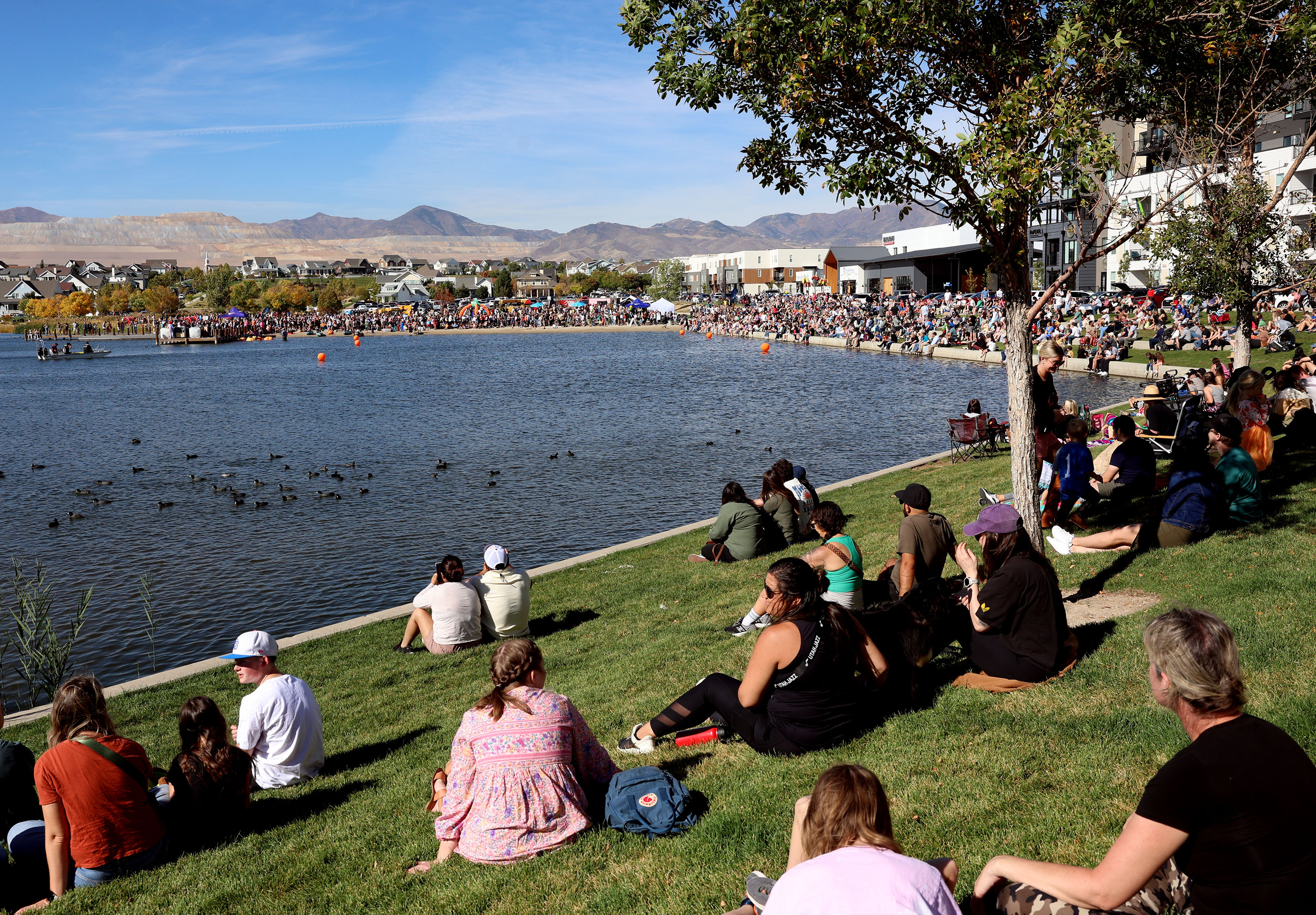 People watch the LiveDAYBREAK Ginormous Pumpkin Regatta at Oquirrh Lake in South Jordan on Saturday, Oct. 12, 2024.