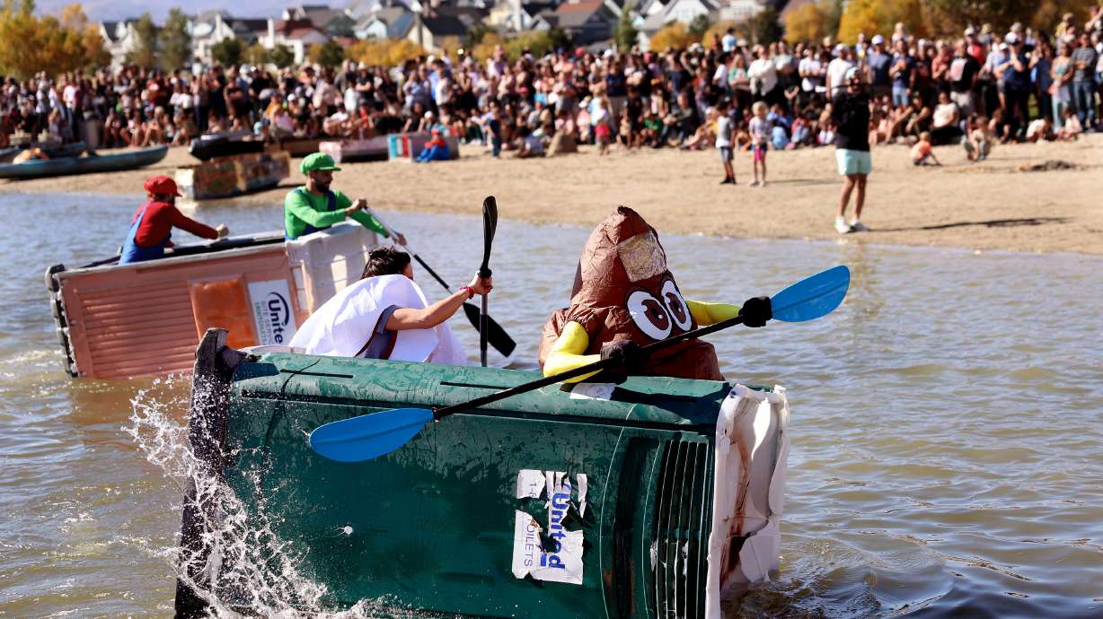 Kayakers compete in the Porta-Paddle race of the LiveDaybreak Ginormous Pumpkin Regatta at Oquirrh Lake in South Jordan on Saturday.