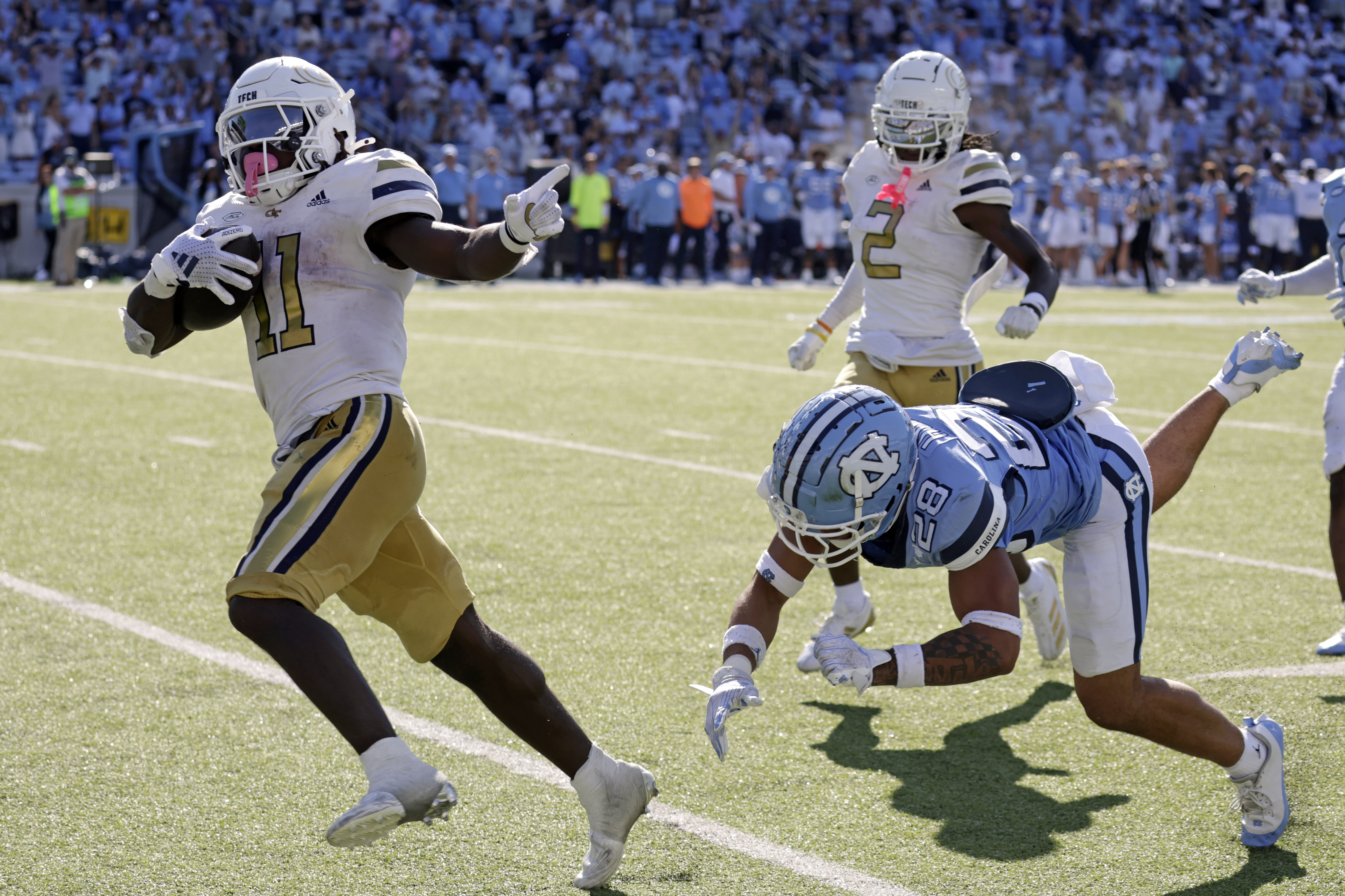 Georgia Tech running back Jamal Haynes (11) outruns North Carolina defensive back Alijah Huzzie (28) to score the winning touchdown on a long run in the closing seconds of an NCAA college football game Saturday, Oct. 12, 2024, in Chapel Hill, N.C.
