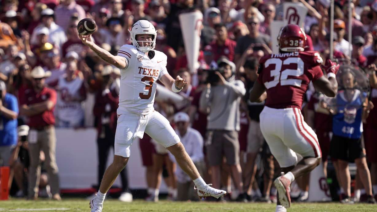Texas quarterback Quinn Ewers (3) throws a pass under pressure from Oklahoma defensive lineman R Mason Thomas (32) in the first half of an NCAA college football game in Dallas, Saturday, Oct. 12, 2024.