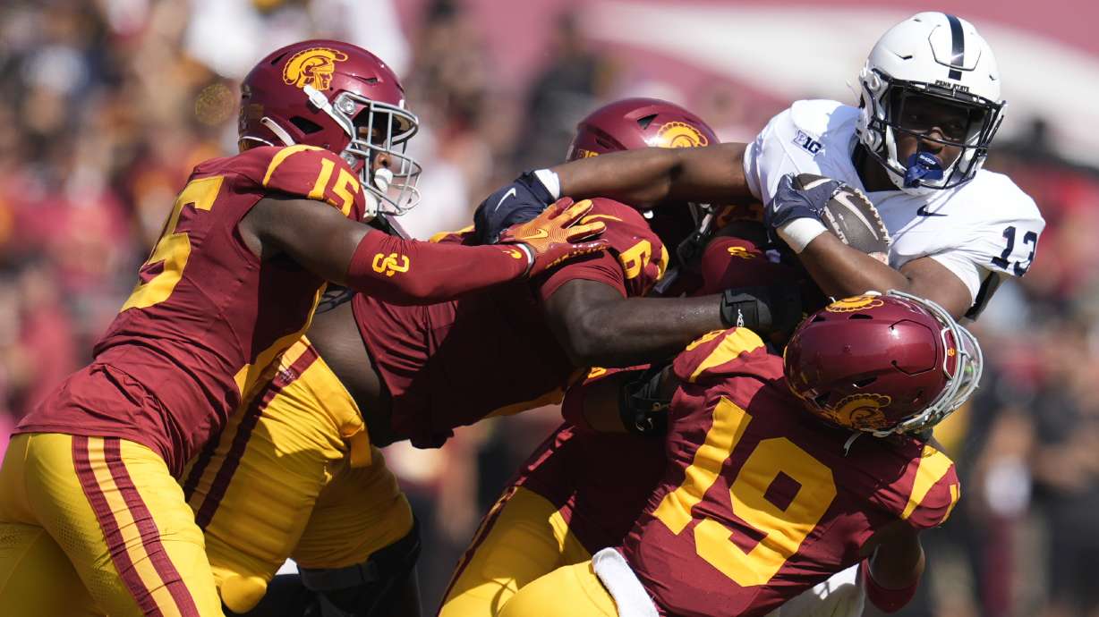 Penn State running back Kaytron Allen (13) is tackled by Southern California cornerback John Humphrey (19), defensive end Anthony Lucas (6) and safety Anthony Beavers Jr. (15) during the first half of an NCAA college football game Saturday, Oct. 12, 2024, in Los Angeles.