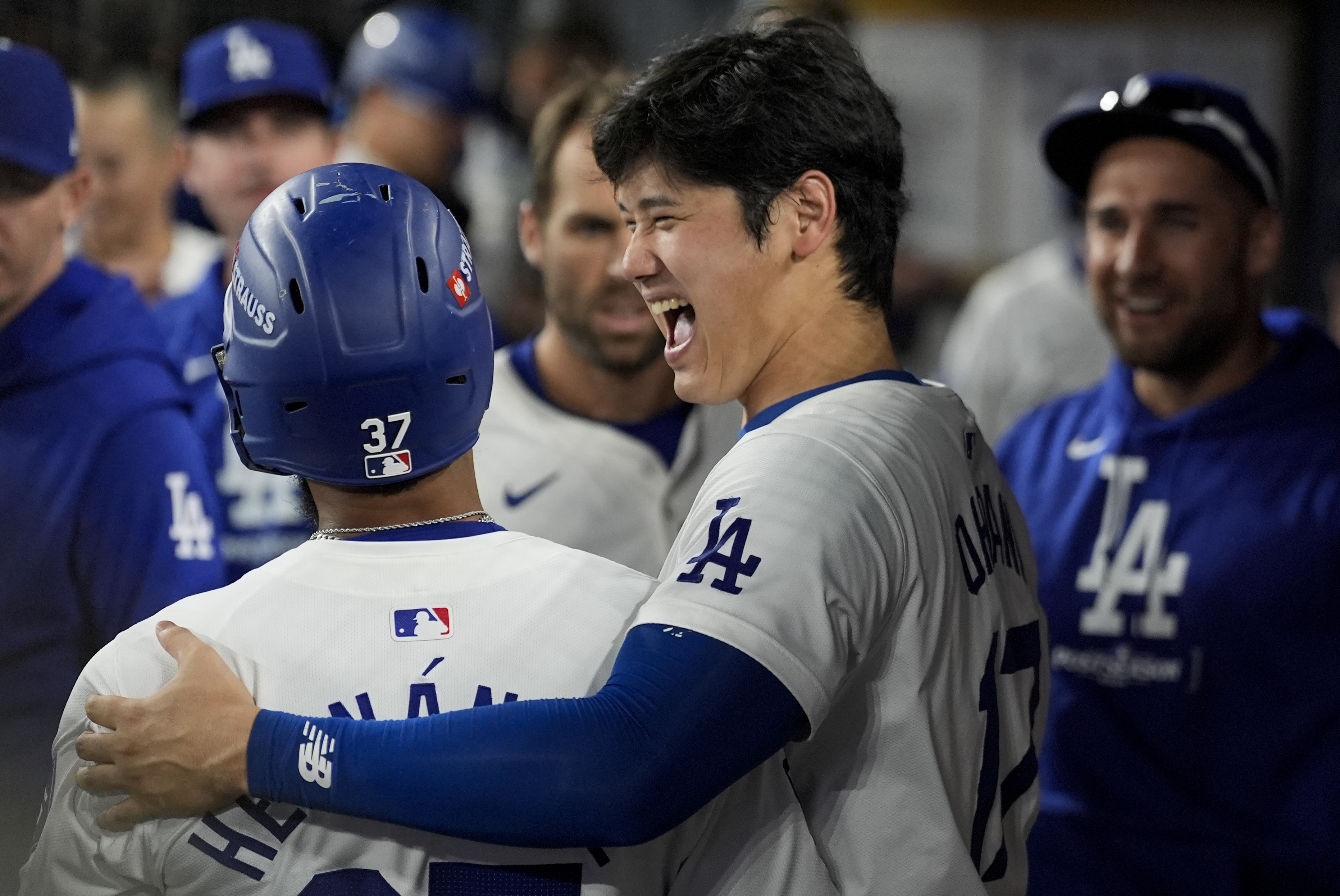 Los Angeles Dodgers' Teoscar Hernández, left, celebrates his solo home run in the dugout with Shohei Ohtani during the seventh inning in Game 5 of a baseball NL Division Series against the San Diego Padres, Friday, Oct. 11, 2024, in Los Angeles.