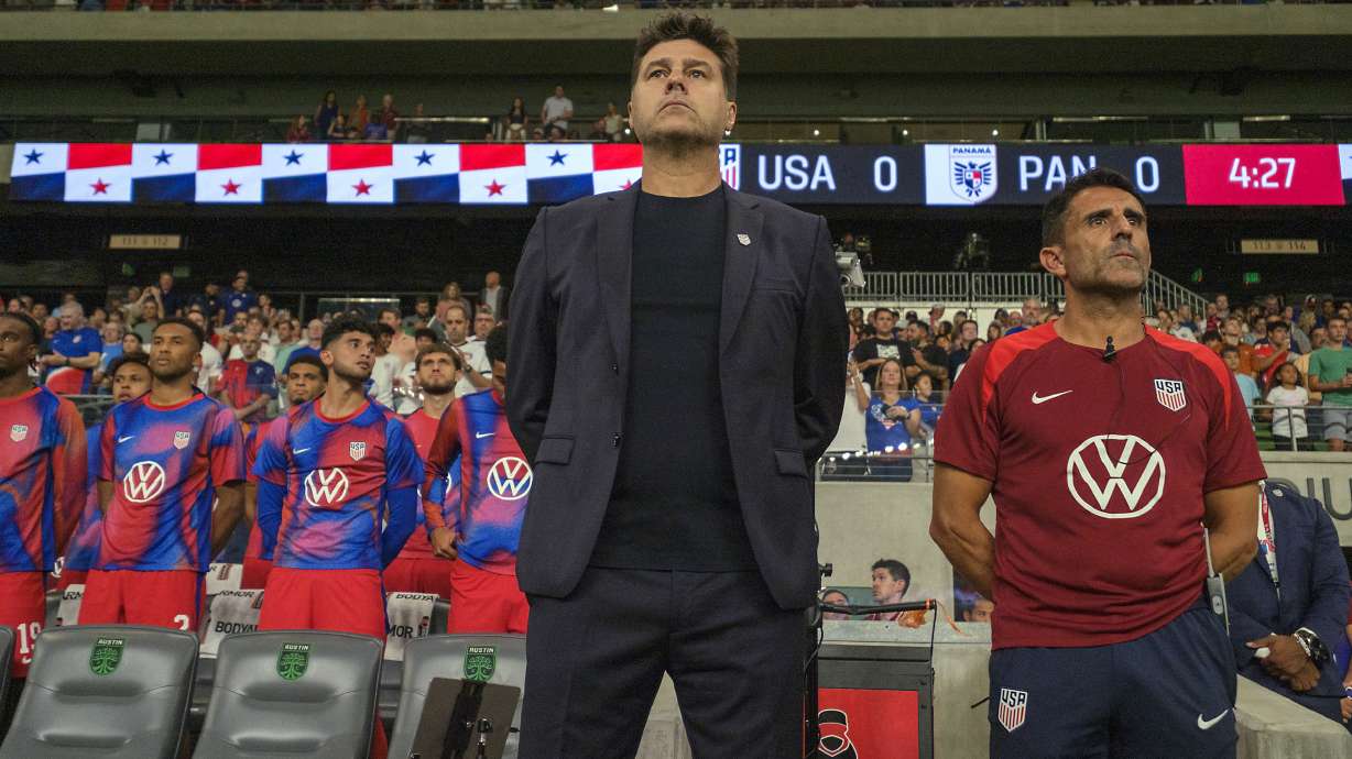 United States head coach Mauricio Pochettino, front left, and first assistant coach Jesus Perez, right, stand for the national anthem before an international friendly soccer match against Panama, Saturday, Oct. 12, 2024, in Austin, Texas.