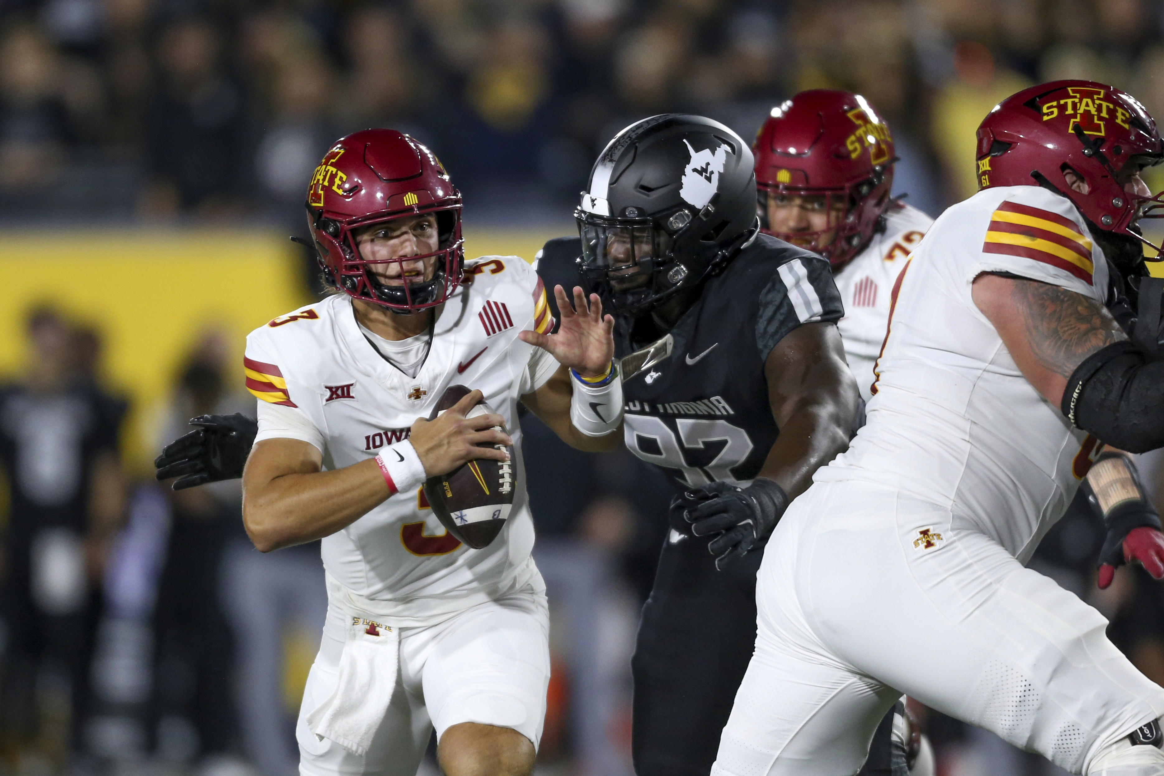 Iowa State quarterback Rocco Becht (3) is sacked by West Virginia defensive lineman Asani Redwood (92) during the first half of an NCAA college football game, Saturday, Oct. 12, 2024, in Morgantown, W.Va.