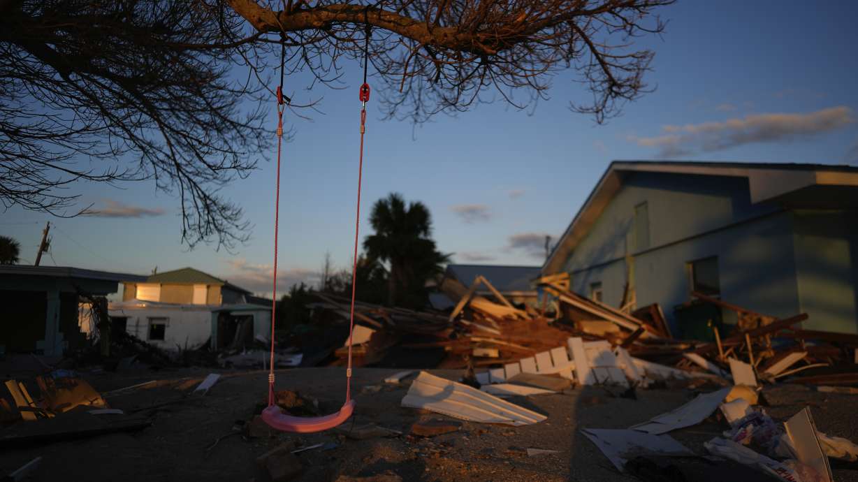 A child's swing still hangs on a tree, surrounded by debris from homes destroyed by Hurricane Milton, on Manasota Key, Fla., Saturday.