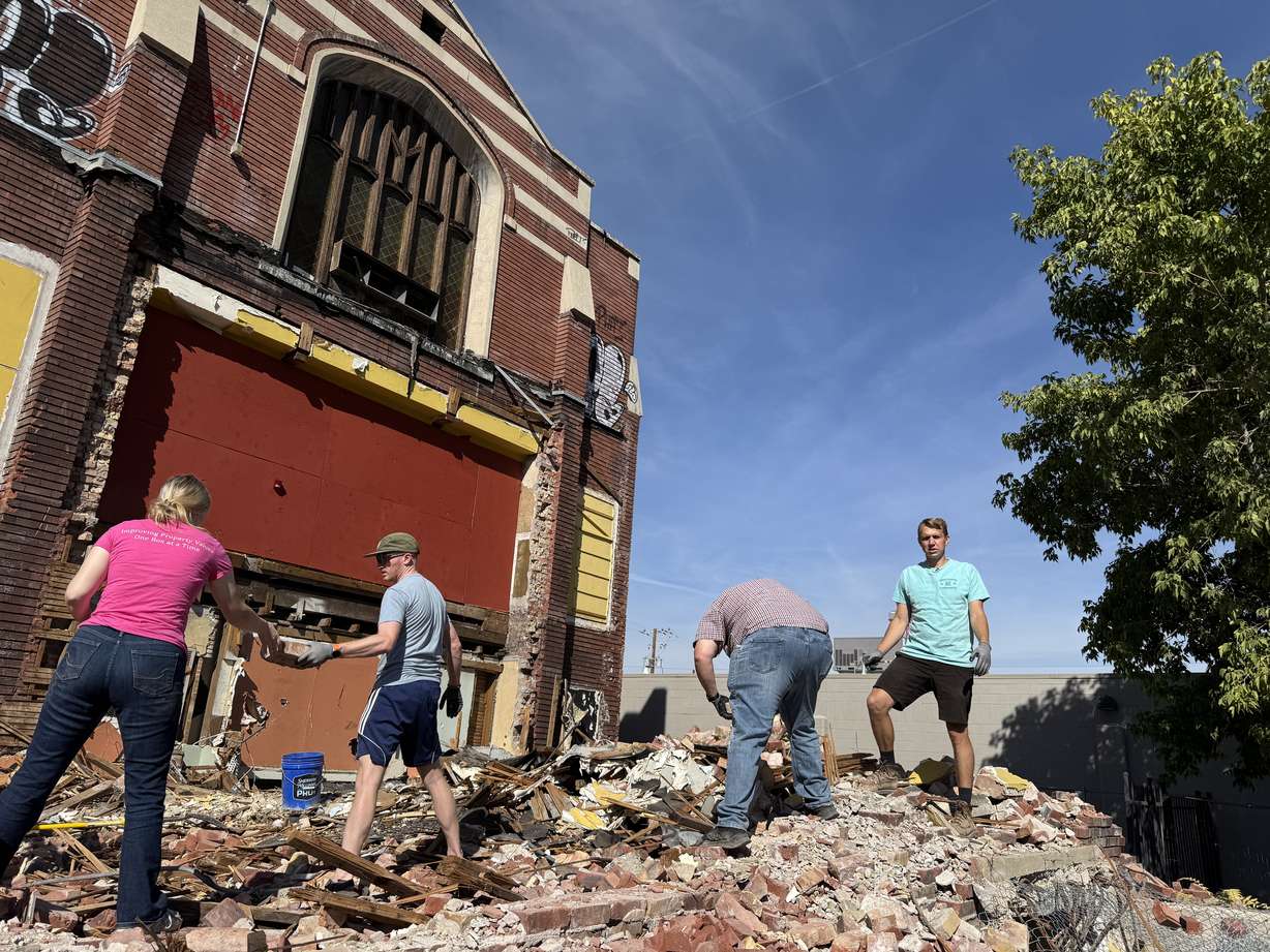 Skyler Baird, right, new owner of the Fifth Ward Meetinghouse sorts bricks with volunteers on Saturday. Baird now has plans to restore the historic church to its original 1910 form using original brick.