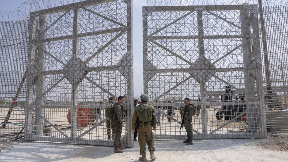 Israeli soldiers gather near a gate to walks through an inspection area for trucks carrying humanitarian aid supplies bound for the Gaza Strip, on the Israeli side of the Erez crossing into northern Gaza, on May 1.