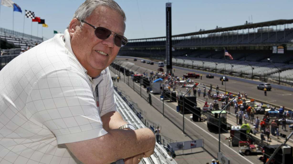 FILE - Associated Press auto racing writer Mike Harris poses along the main straightway at the Indianapolis Motor Speedway in Indianapolis, on May 20, 2009.