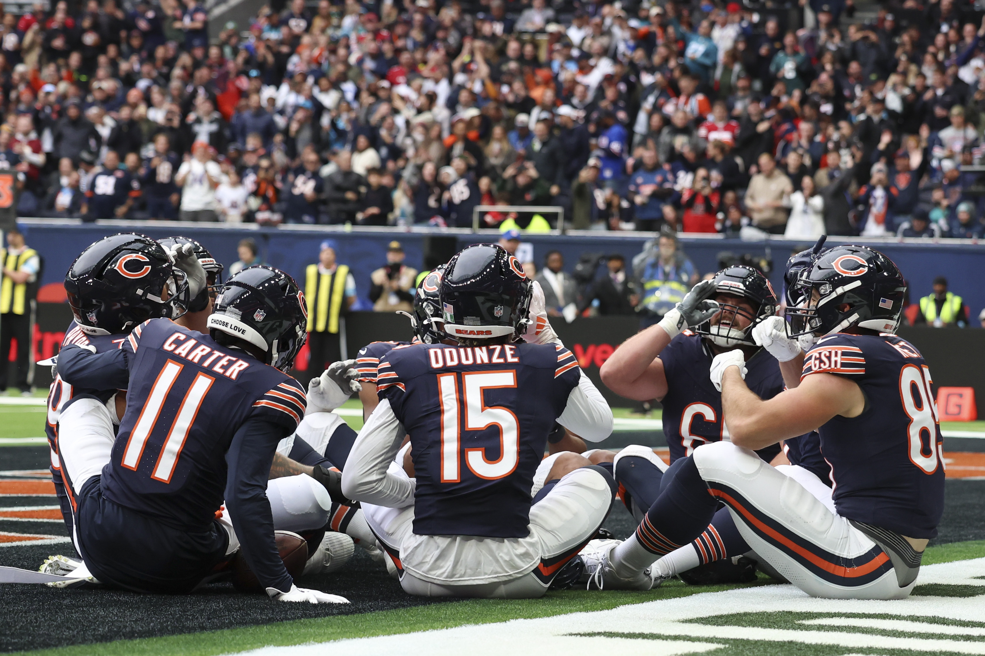 Bears players celebrate after Chicago Bears wide receiver Keenan Allen (13) scored his side's third touchdown during the third quarter of an NFL football game at the Tottenham Hotspur stadium between the Jacksonville Jaguars and Chicago Bears in London, Sunday, Oct. 13, 2024.