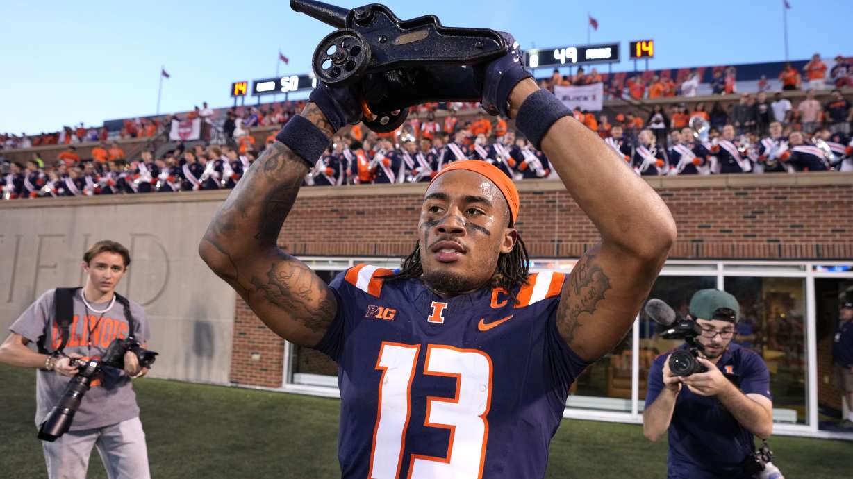 Illinois wide receiver Pat Bryant celebrates with the Purdue cannon after the team's 50-49 overtime win over Purdue in an NCAA college football game Saturday, Oct. 12, 2024, in Champaign, Ill.