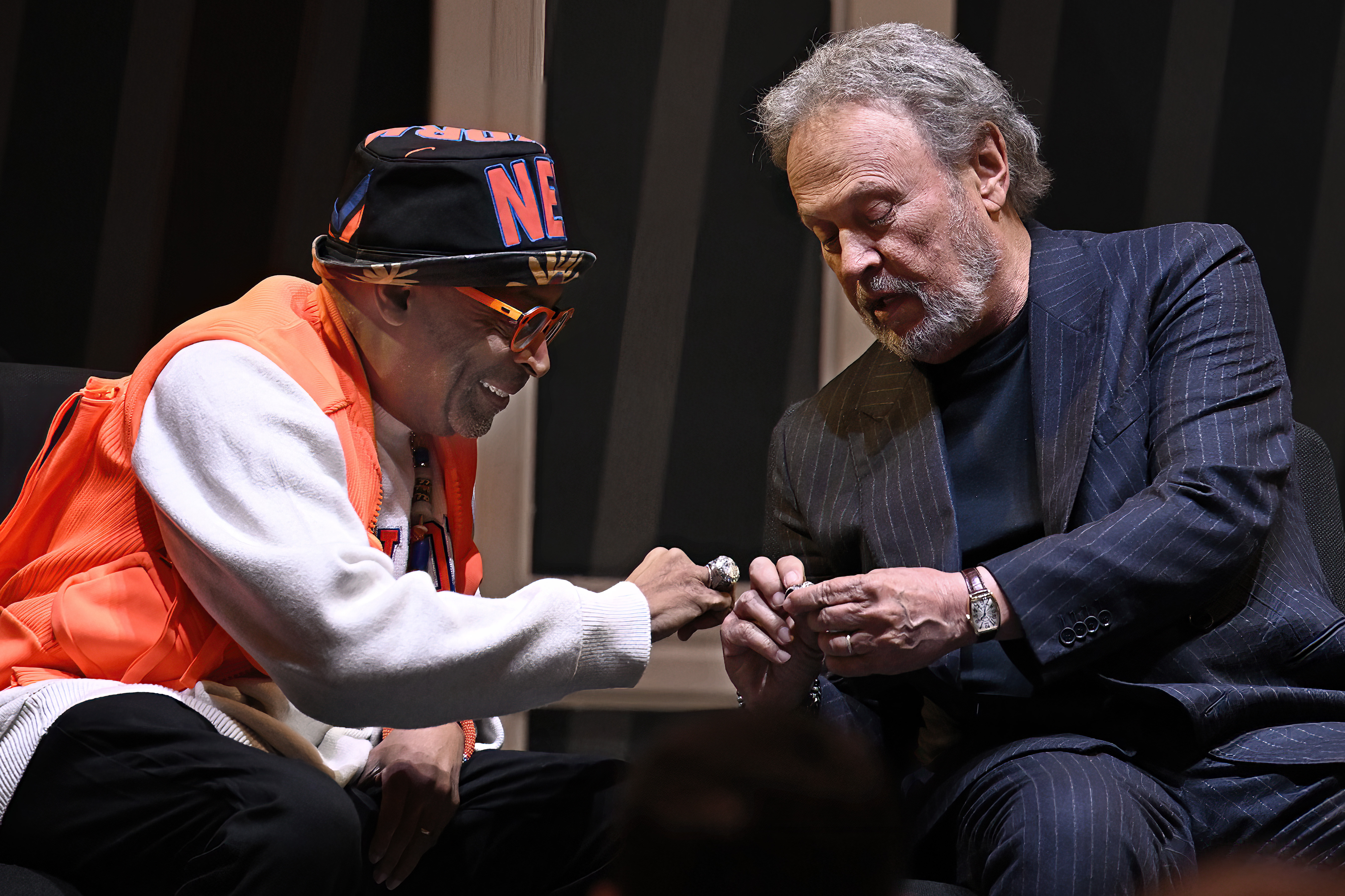 Film director Spike Lee, left, and comedian Billy Crystal, right, compare rings as they are honored at a superfan ceremony at the Basketball Hall of Fame, Sunday, Oct. 13, 2024, in Springfield, Mass. Lee, Crystal, actor Jack Nicholson and businessman Alan Horwitz are being added to the Naismith Memorial Basketball Hall of Fame's James F. Goldstein SuperFan Gallery.