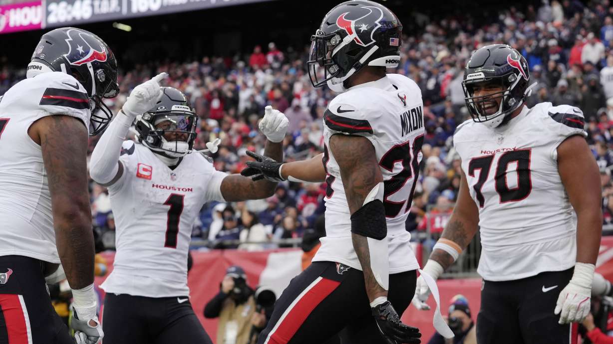 Houston Texans running back Joe Mixon (28) celebrates after his touchdown with wide receiver Stefon Diggs (1) and center Juice Scruggs (70) during the second half of an NFL football game against the New England Patriots, Sunday, Oct. 13, 2024, in Foxborough, Mass.