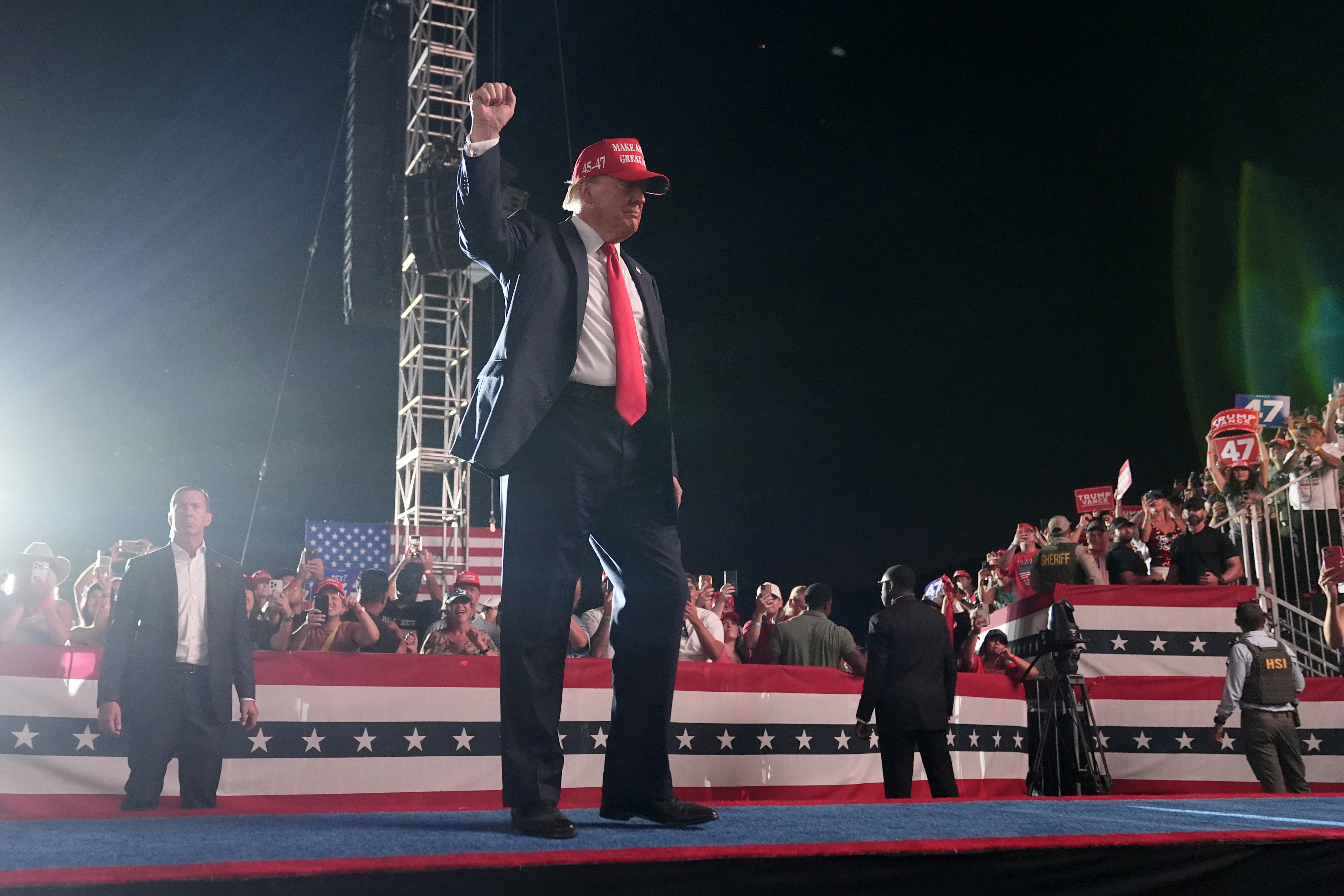 Republican presidential nominee former President Donald Trump gestures to the audience as he departs a campaign rally at the Calhoun Ranch, Saturday, in Coachella, Calif. 