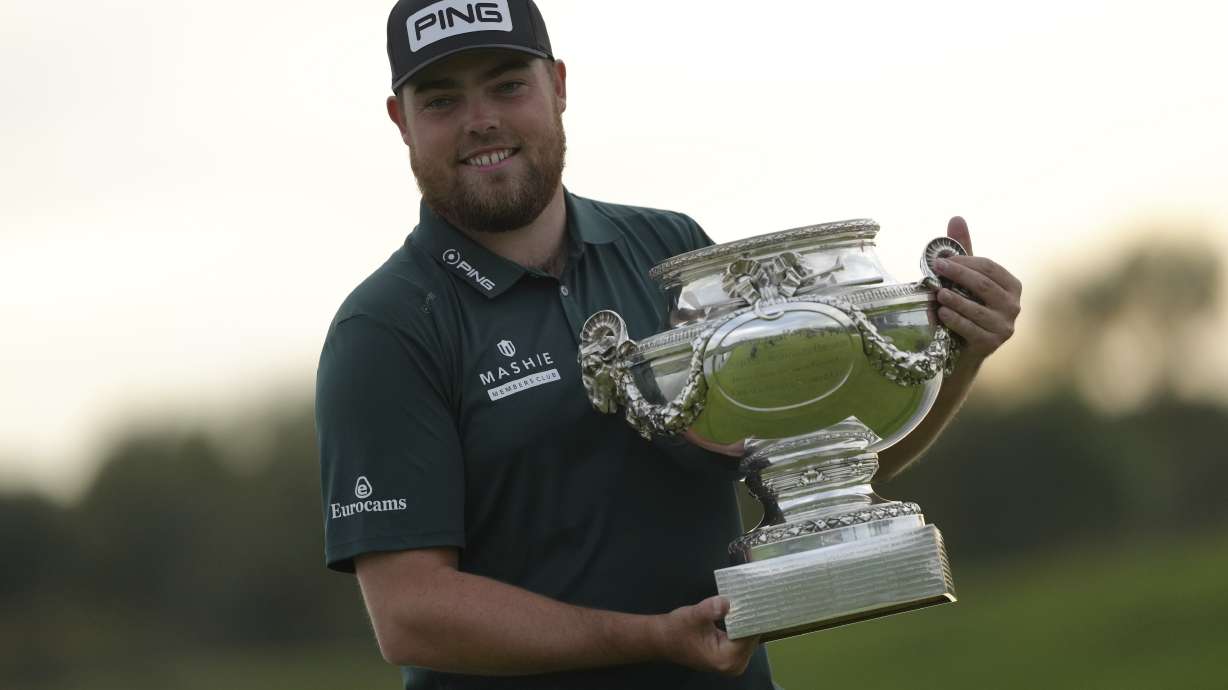Dan Bradbury of England poses for photographers with the trophy after winning the Golf French Open at Le Golf National in Saint-Quentin-en-Yvelines, outside Paris, France, Sunday, Oct. 13, 2024.