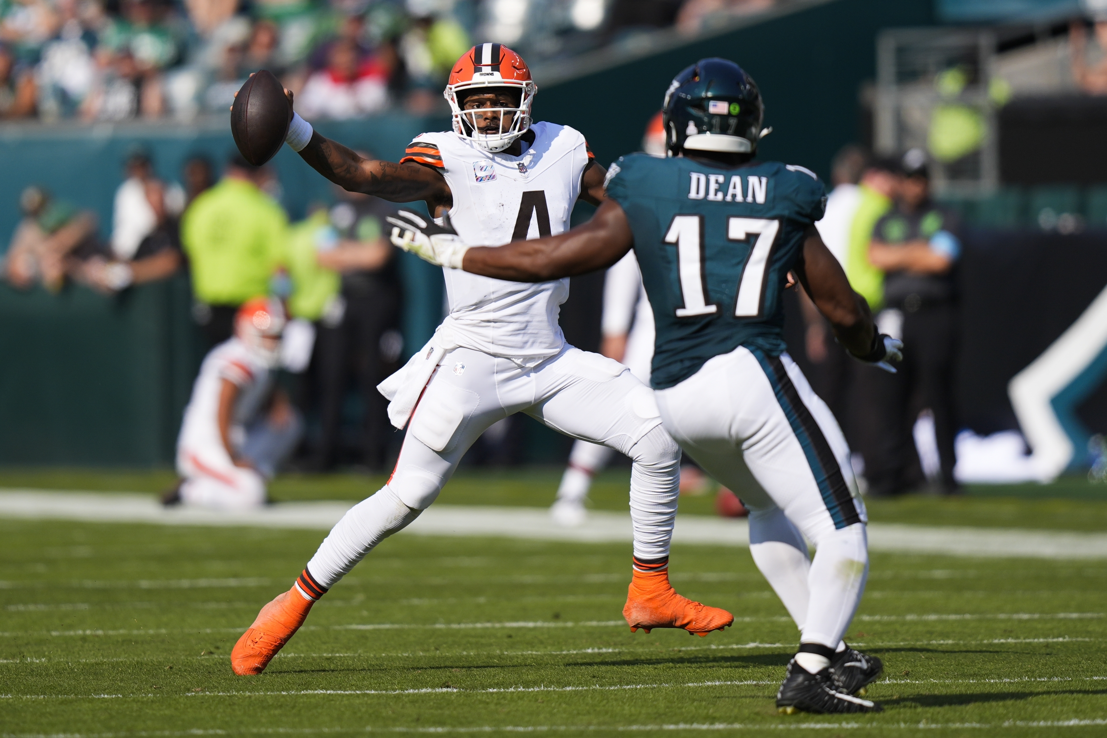 Cleveland Browns quarterback Deshaun Watson (4) scrambles with the ball as Philadelphia Eagles linebacker Nakobe Dean (17) defends during the second half of an NFL football game Sunday, Oct. 13, 2024, in Philadelphia.