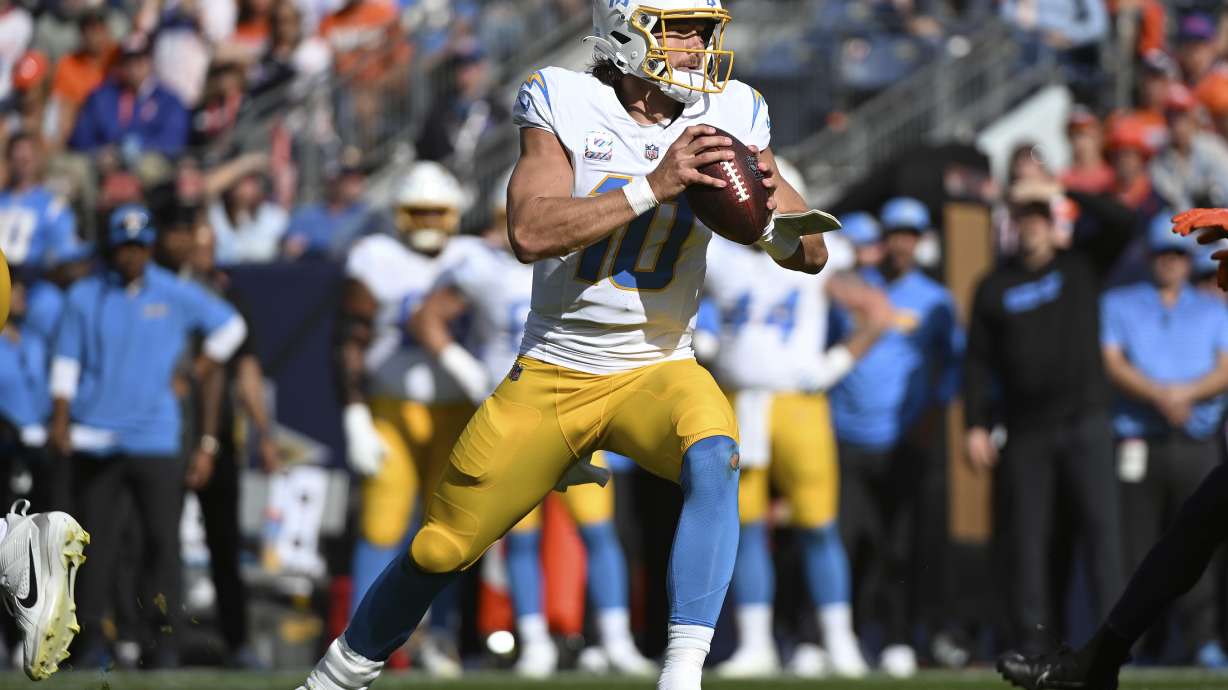 Los Angeles Chargers quarterback Justin Herbert (10) looks to pass during the first half of an NFL football game against the Denver Broncos, Sunday, Oct. 13, 2024, in Denver.