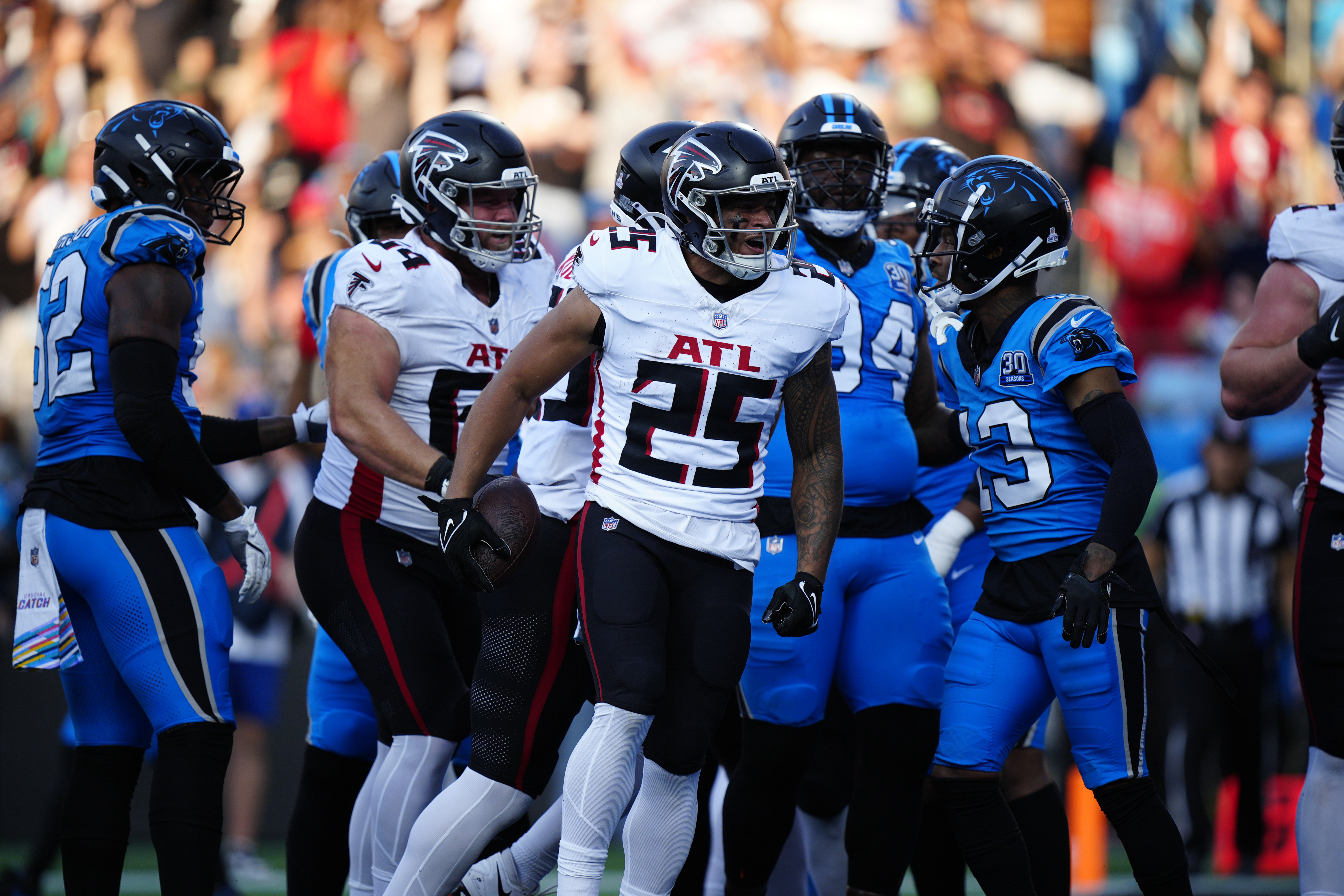 Atlanta Falcons running back Tyler Allgeier (25) celebrates after running in a a 2-point conversion in the first half of an NFL football game against the Carolina Panthers in Charlotte, N.C., Sunday, Oct. 13, 2024.