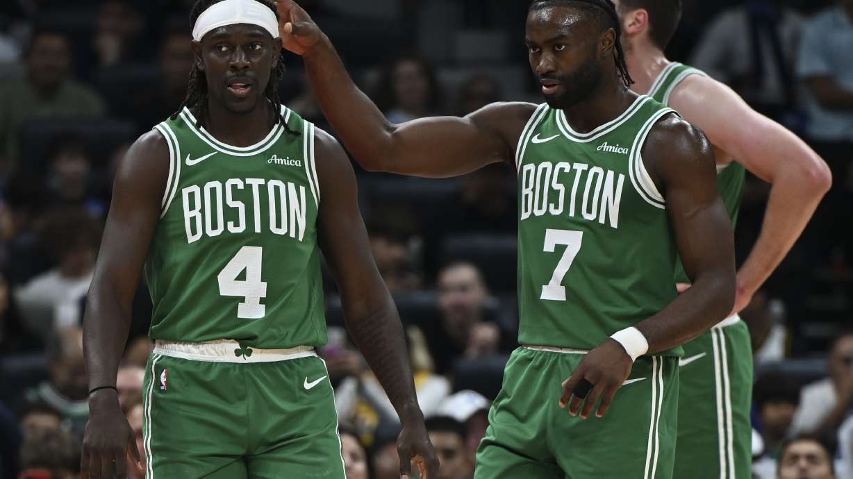 Boston Celtics Jrue Holiday, left, and Boston Celtics Jaylen Brown stand during a preseason game between Boston Celtics and Denver Nuggets in Abu Dhabi, United Arab Emirates, Friday, Oct. 4, 2024.