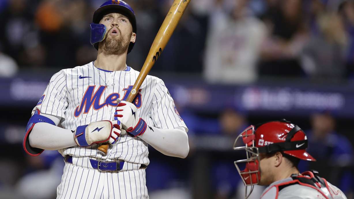 New York Mets' Brandon Nimmo reacts after striking out against the Philadelphia Phillies with runners on base during the fifth inning of Game 4 of the National League baseball playoff series, Wednesday, Oct. 9, 2024, in New York.