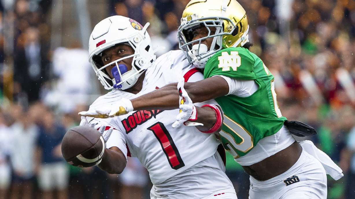 Notre Dame defensive back Benjamin Morrison (20), right, knocks the ball away from Louisville wide receiver Ja'Corey Brooks (1) during the first half of an NCAA college football game Saturday, Sept. 28, 2024, in South Bend, Ind.
