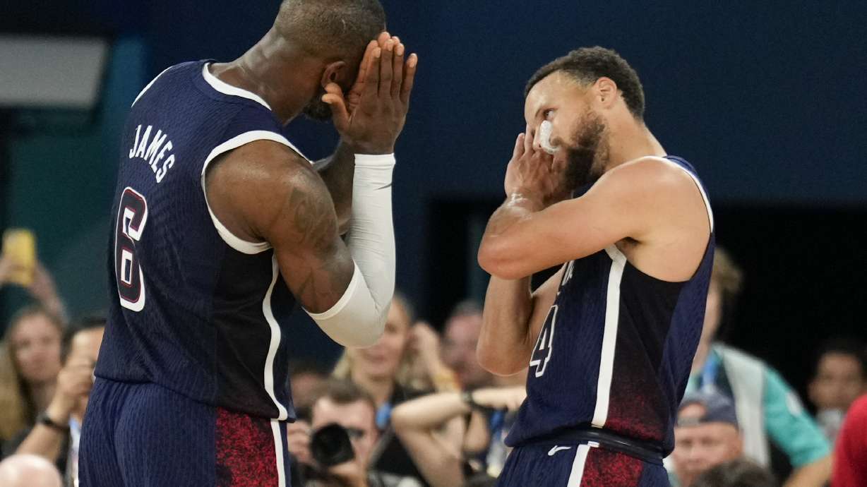 FILE - United States' Stephen Curry (4) and LeBron James (6) celebrate after beating France to win the gold medal during a men's gold medal basketball game at Bercy Arena at the 2024 Summer Olympics, Aug. 10, 2024, in Paris, France.