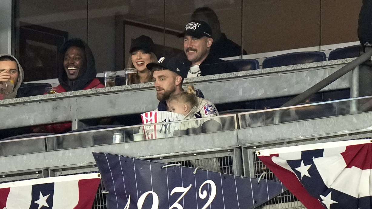 Travis Kelce, top right, and Taylor Swift watch Game 1 of the baseball AL Championship Series between the Cleveland Guardians and New York Yankees Monday, Oct. 14, 2024, in New York.