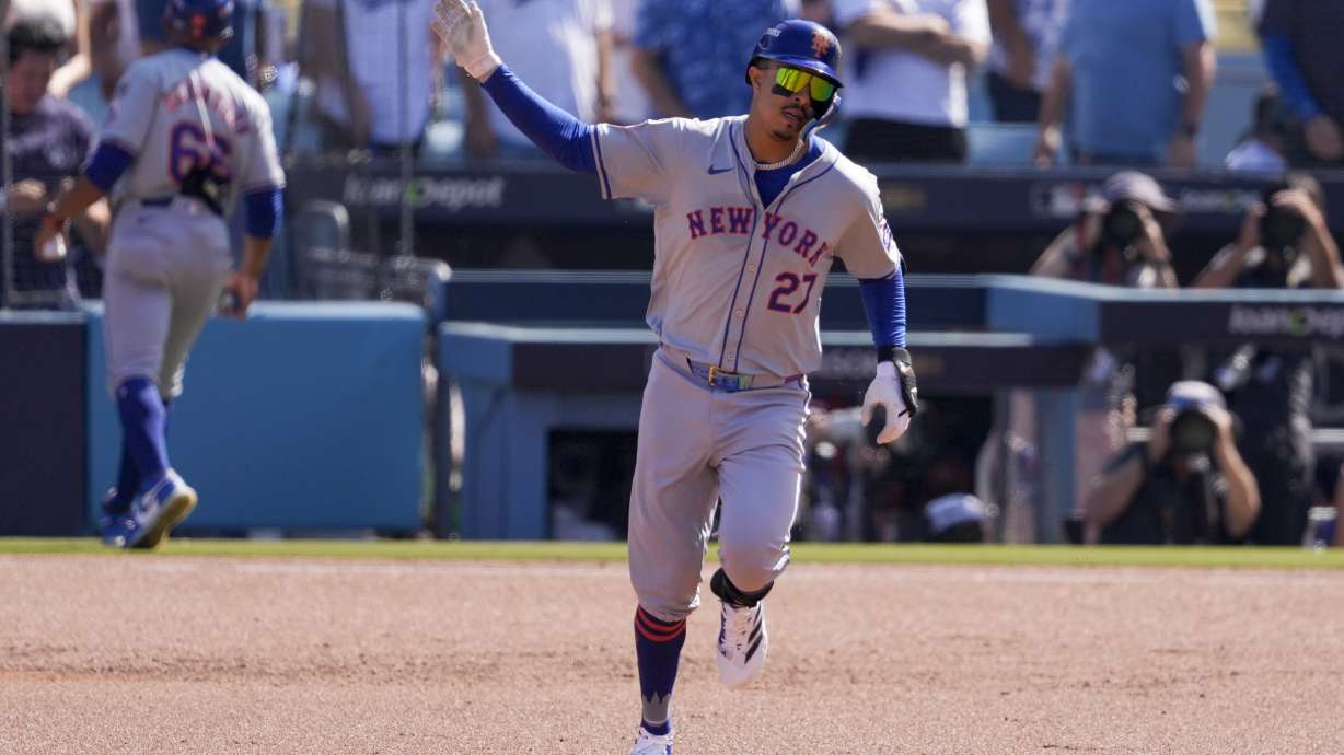 New York Mets' Mark Vientos celebrates as he rounds the bases after his grand slam home run against the Los Angeles Dodgers during the second inning in Game 2 of a baseball NL Championship Series, Monday, Oct. 14, 2024, in Los Angeles.