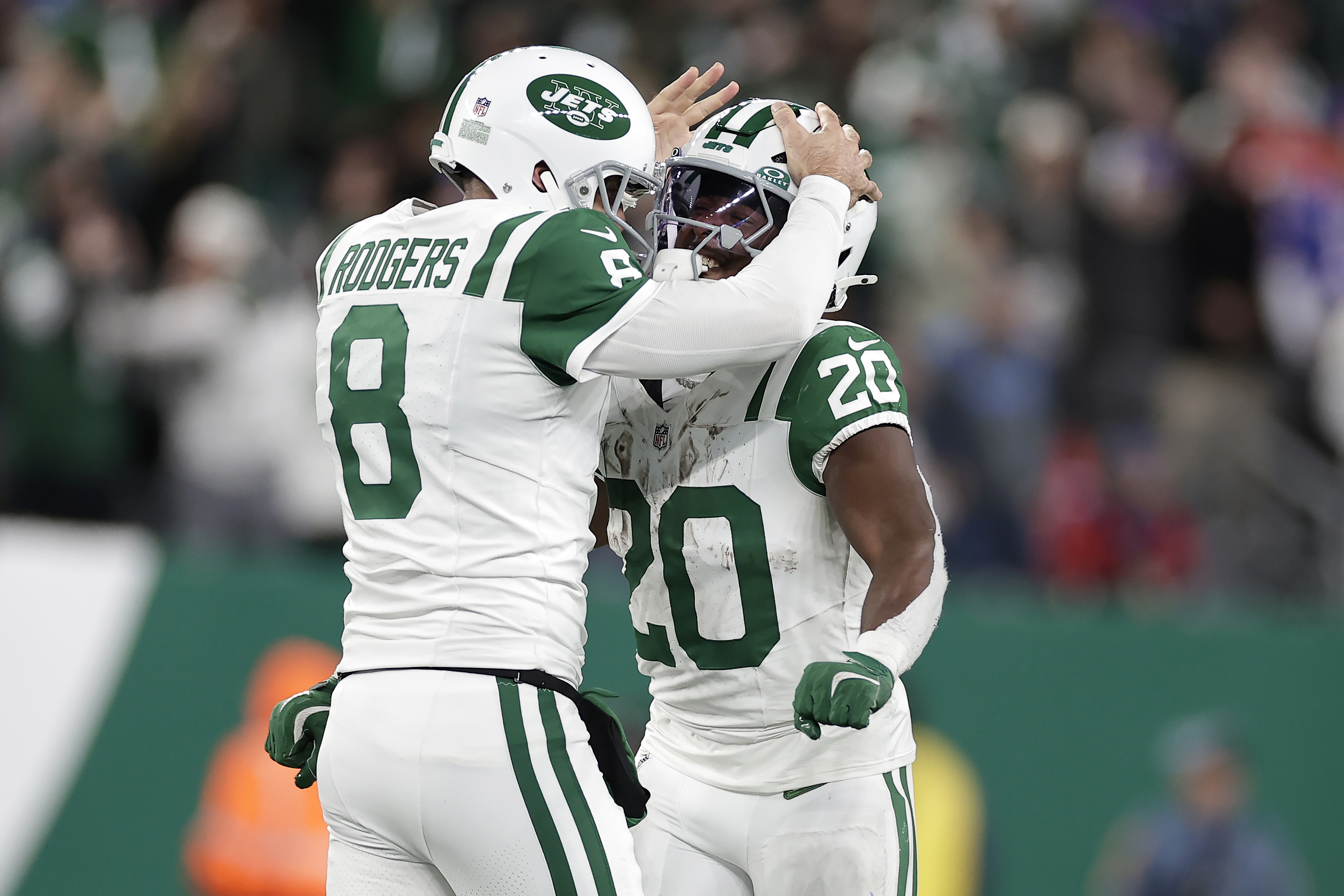 New York Jets quarterback Aaron Rodgers (8) celebrates with running back Frank Gore Jr. (20) after throwing a touchdown pass to wide receiver Allen Lazard during the first half of an NFL football game against the Buffalo Bills in East Rutherford, N.J., Monday, Oct. 14, 2024.