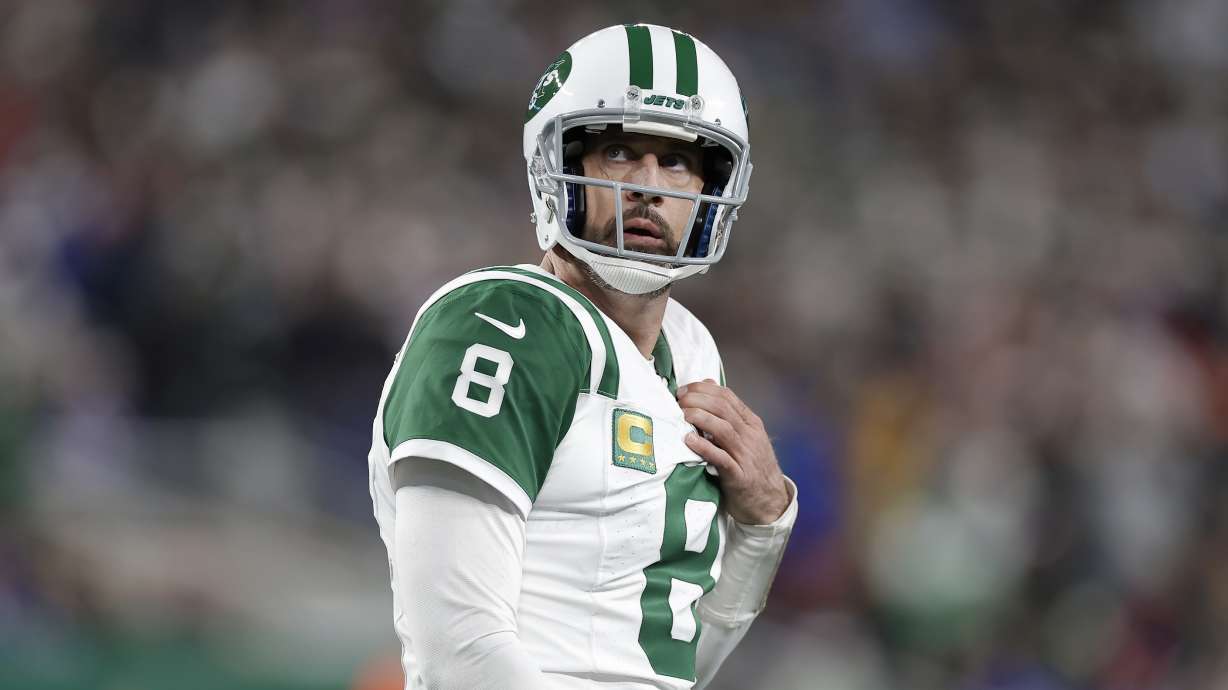 New York Jets quarterback Aaron Rodgers walks on the field during the second half of an NFL football game against the Buffalo Bills in East Rutherford, N.J., Monday, Oct. 14, 2024.