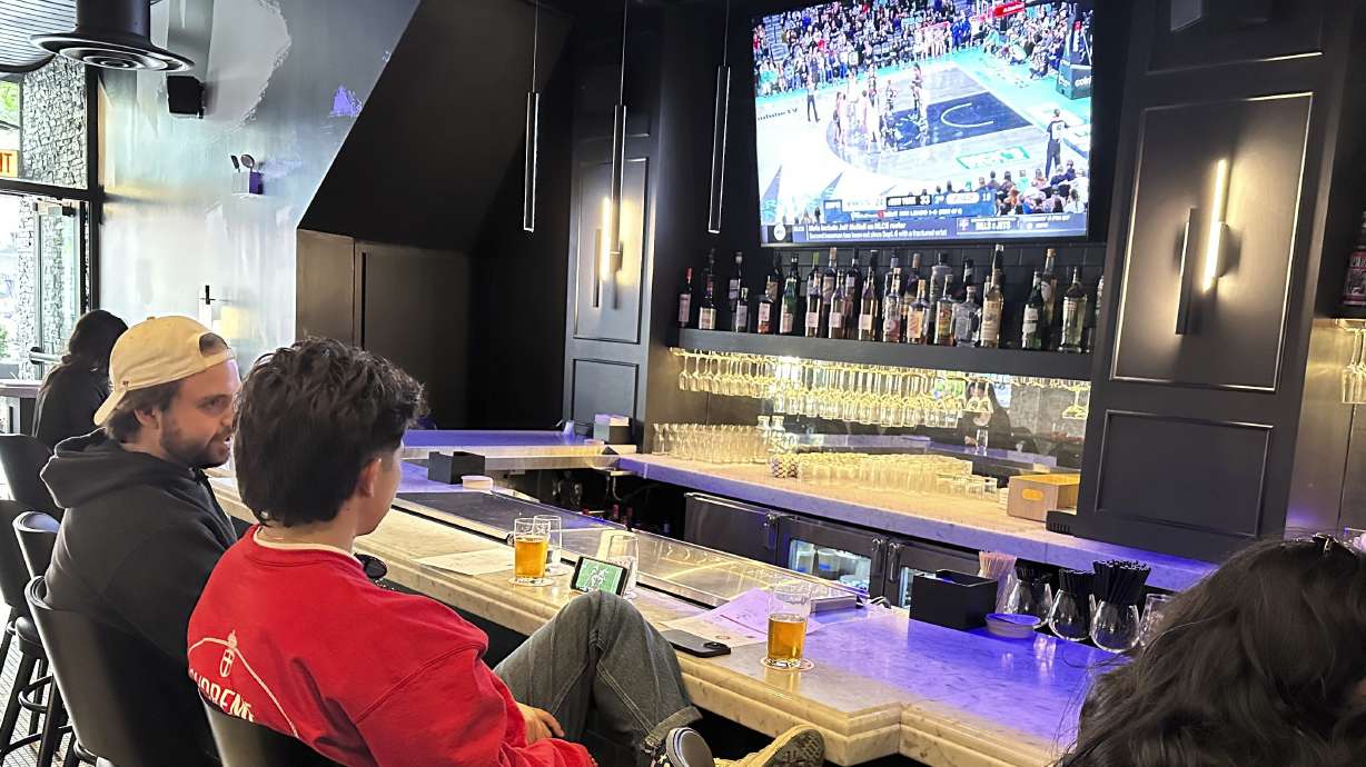 Customers at Signature Bar & Restaurant in Chicago’s South Loop neighborhood near the Chicago Sky’s home at Wintrust Arena sit at the bar as Game 2 of the WNBA finals between the New York Liberty and Minnesota Lynx is shown on a TV on Sunday, Oct. 13, 2024. The WNBA drew sellout crowds and unprecedented ratings in a transformational season. Sports-oriented bars and restaurants are taking note. Some say they’re seeing an increased demand for women’s sports on their TVs.