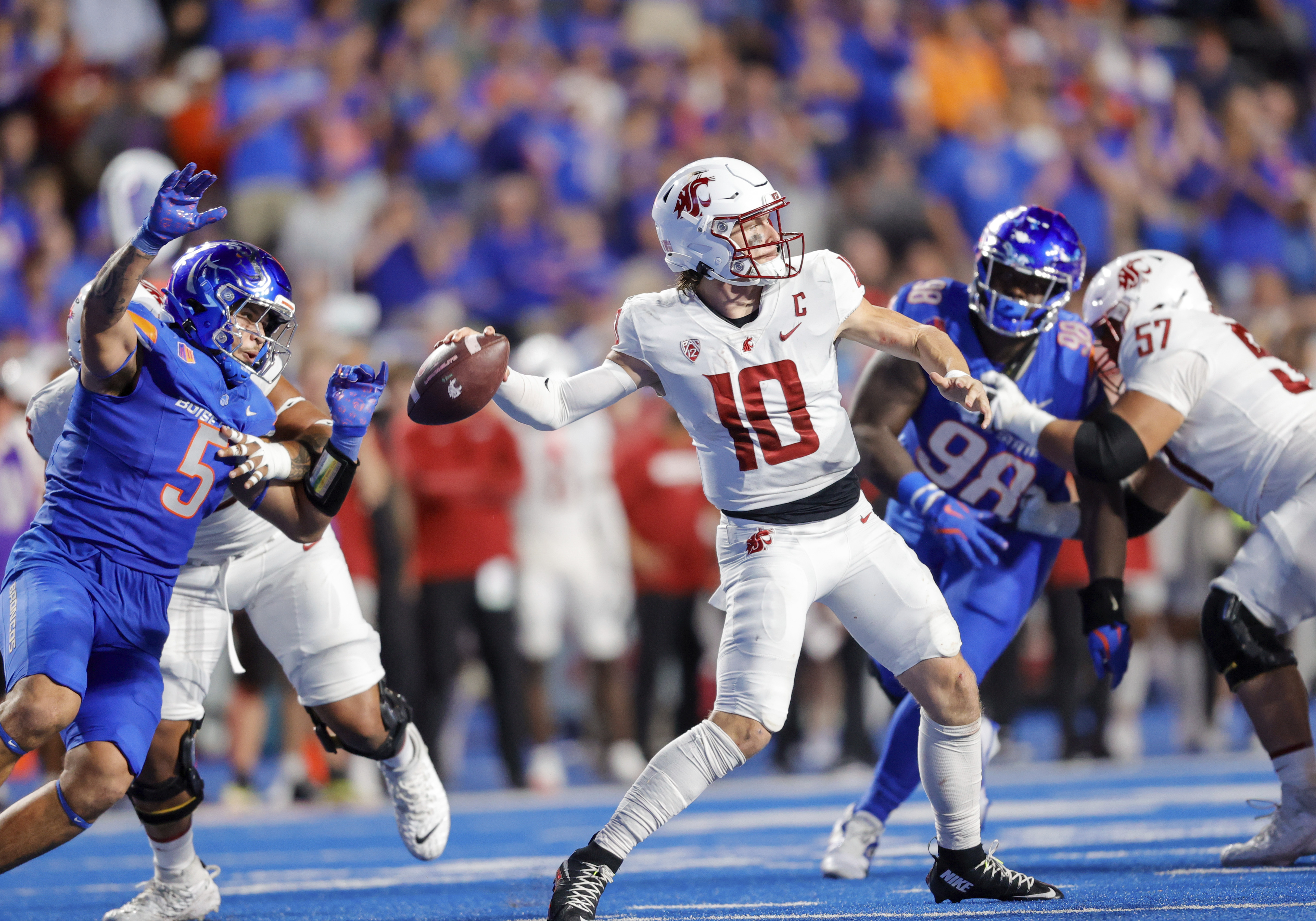 Washington State quarterback John Mateer (10) throws the ball while pressured by Boise State defensive end Jayden Virgin-Morgan (5) late in the second half of an NCAA college football game, Saturday, Sept. 28, 2024, in Boise, Idaho.