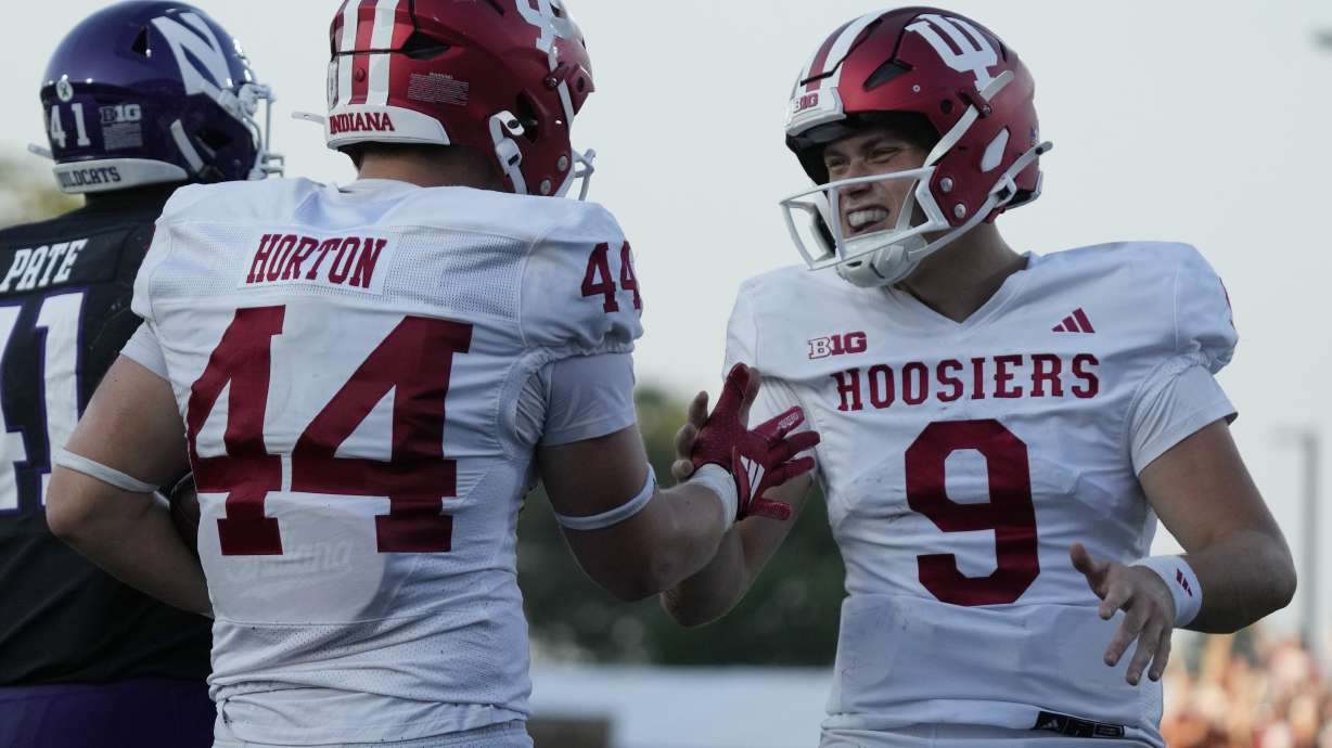 Indiana tight end Zach Horton, left, celebrates with quarterback Kurtis Rourke after scoring a touchdown during the second half of an NCAA college football game against Northwestern in Evanston, Ill., Saturday, Oct. 5, 2024.