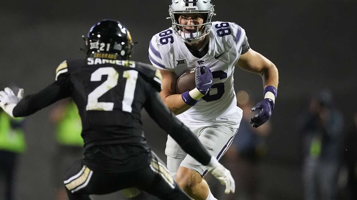 Kansas State tight end Garrett Oakley, back, looks for room to run after catching a pass as Colorado safety Shilo Sanders prepares to make the tackle in the second half of an NCAA college football game Saturday, Oct. 12, 2024, in Boulder, Colo.