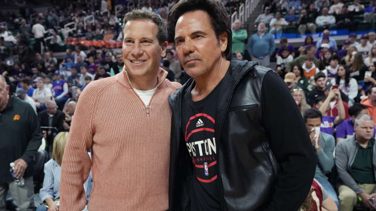Phoenix Suns owner Mat Ishbia, left, meets with Detroit Pistons owner Tom Gores before the NBA preseason basketball game, Tuesday, Oct. 8, 2024, in East Lansing, Mich.
