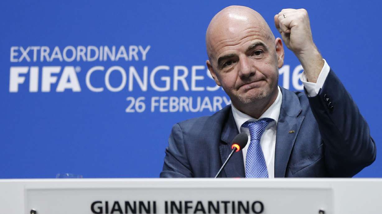 FILE - Newly elected FIFA president Gianni Infantino of Switzerland raises an arm during a press conference in Zurich, Switzerland, Feb. 26, 2016.
