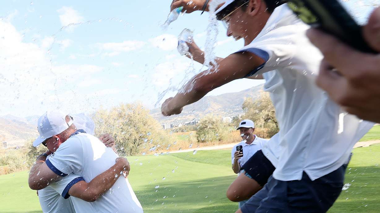Corner Canyon head golf coach Derek Fox gets doused in water after Corner Canyon won the 6A boys golf state championship at Riverbend Golf Course in Riverton on Tuesday, Oct. 15, 2024.