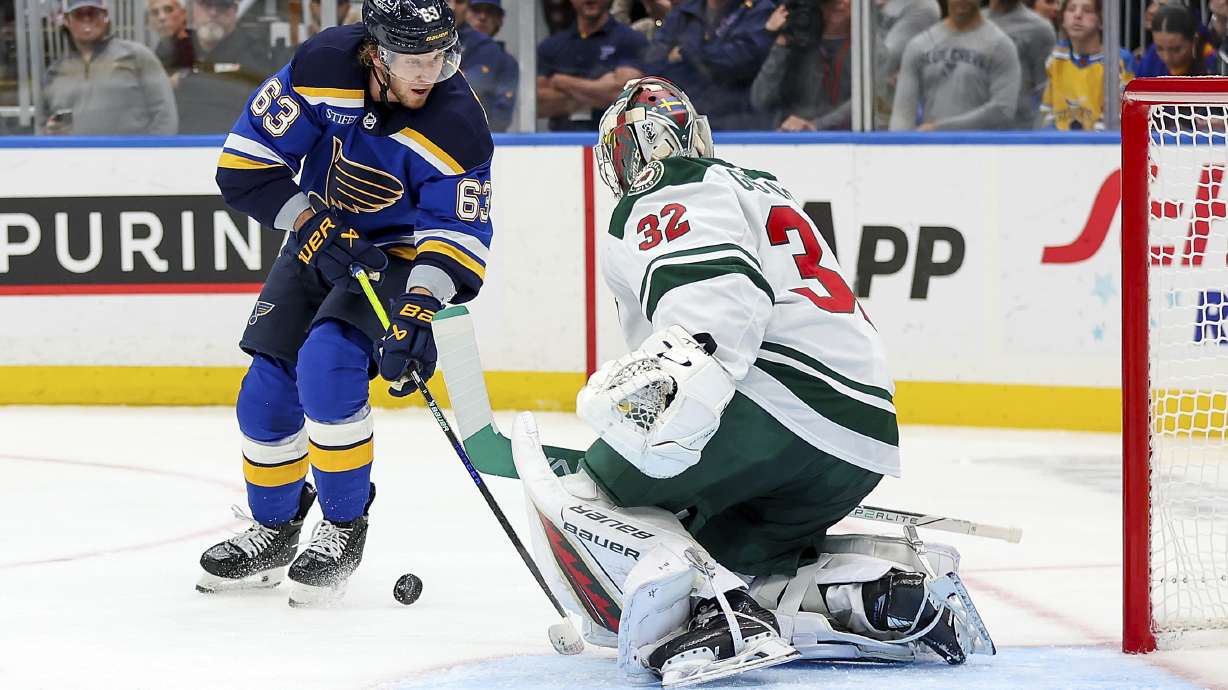 Minnesota Wild goaltender Filip Gustavsson (32) defends against St. Louis Blues' Jake Neighbours (63) during the second period of an NHL hockey game Tuesday, October 15, 2024, in St. Louis.
