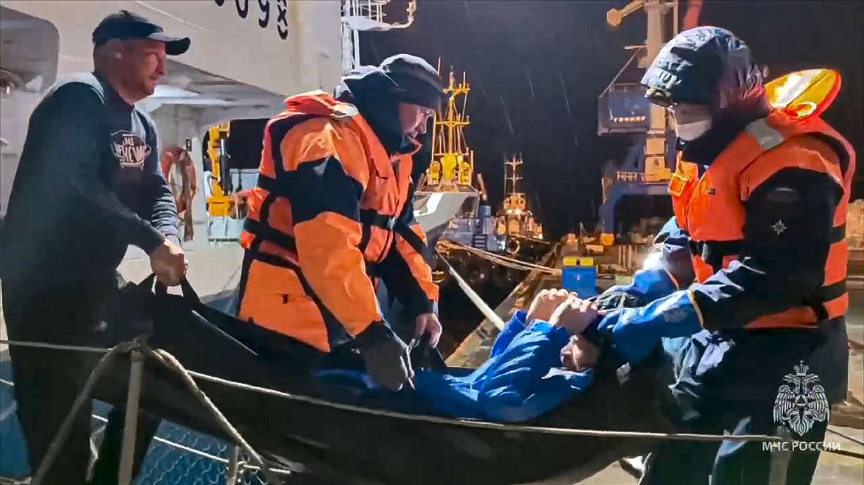In this photo released on Tuesday, Russian emergency workers pull Mikhail Pichugin ashore after he was rescued by a fishing vessel following 67 days adrift in the Sea of Okhotsk in the Russian far east.