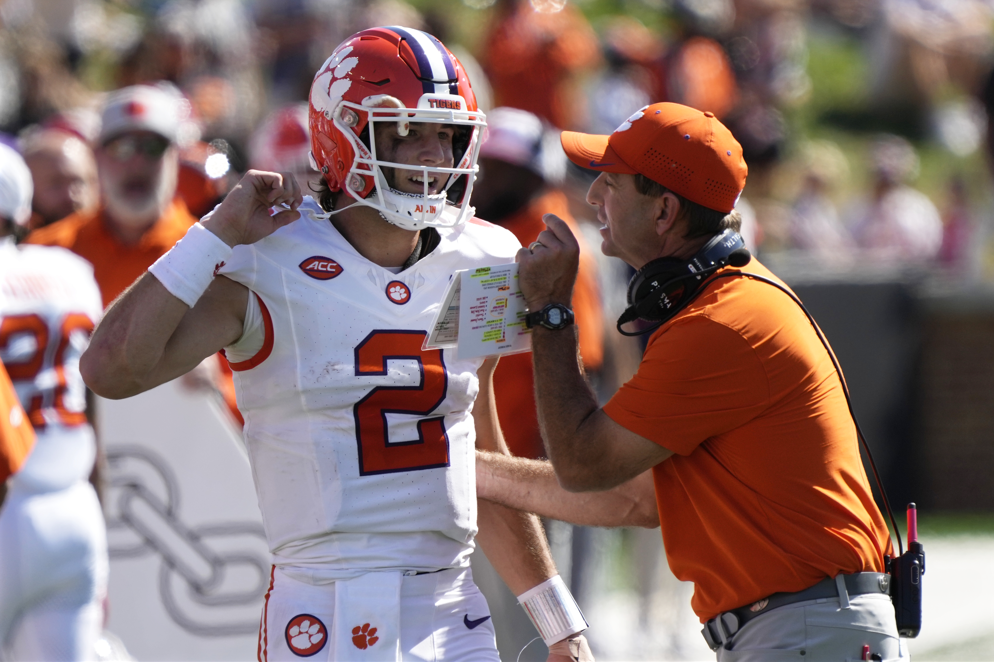 Clemson head coach Dabo Swinney, right, talks with quarterback Cade Klubnik (2) during the first half of an NCAA football game against Wake Forest in Greensboro, N.C., Saturday, Oct. 12, 2024.