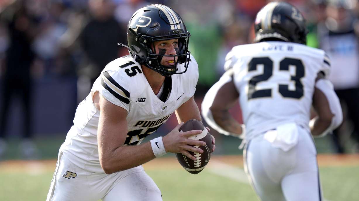 Purdue quarterback Ryan Browne carries the ball during the first half of an NCAA college football game against Illinois on Saturday, Oct. 12, 2024, in Champaign, Ill.
