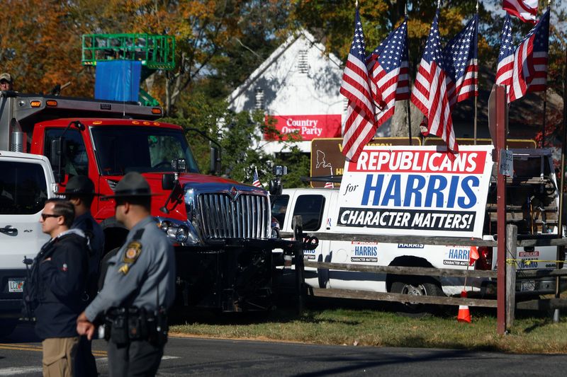 U.S. flags stand on a vehicle with stickers supporting Democratic presidential nominee Vice President Kamala Harris, on the day she attends a campaign event in Bucks County, Pa., Wednesday.