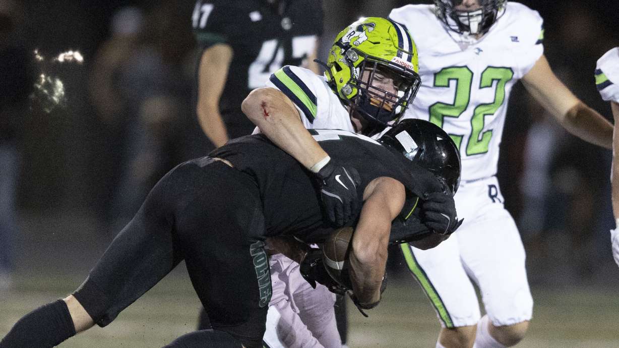 Ridgeline’s Krew Jones (40) tackles Green Canyon’s Shandon Thain (3) at Green Canyon High School in Logan on Friday, Sept. 13, 2024.
