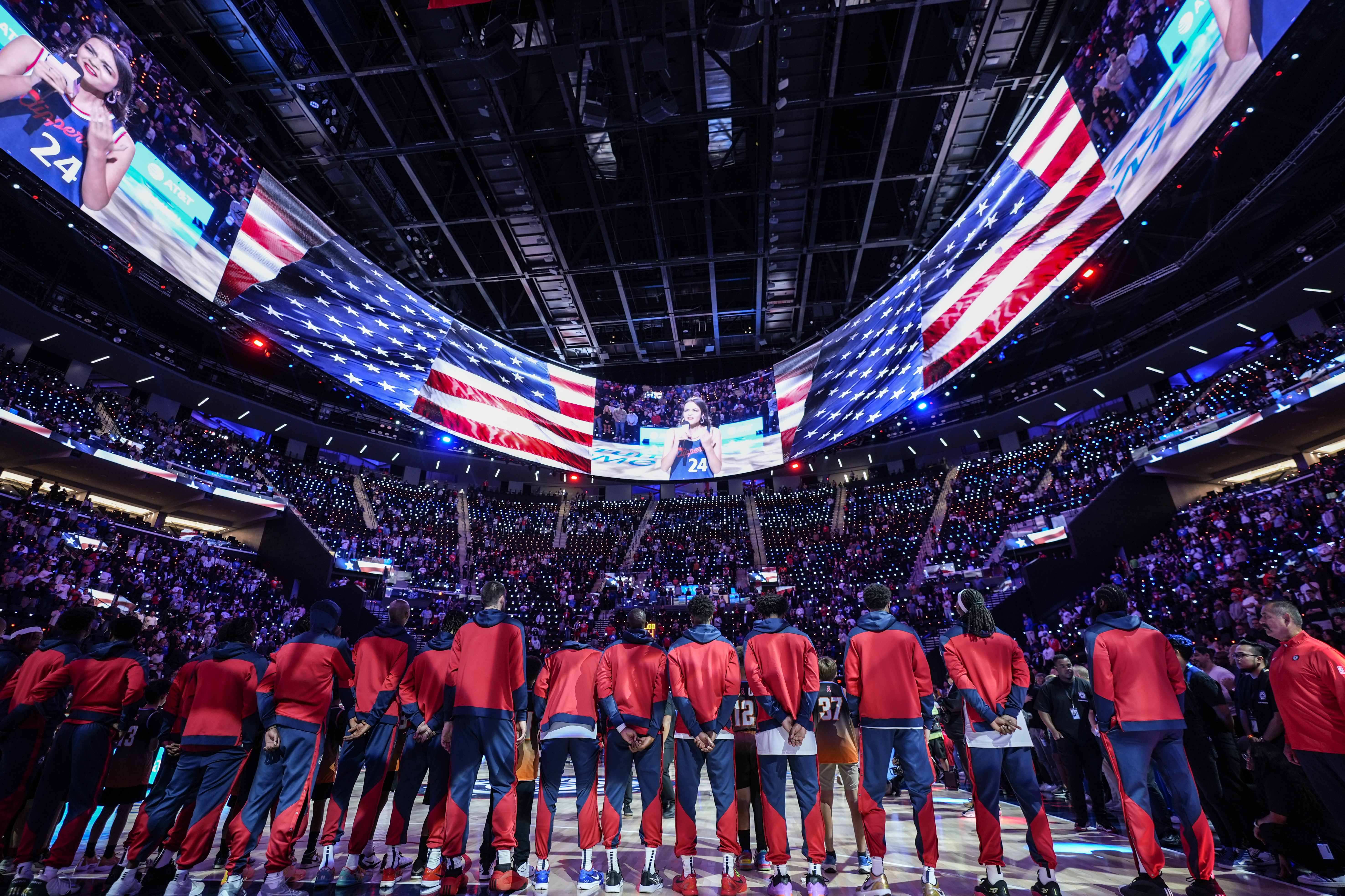Los Angeles Clippers players listen to the national anthem before an NBA preseason basketball game against the Dallas Mavericks at Intuit Dome in Inglewood, Calif., Monday, Oct. 14, 2024.