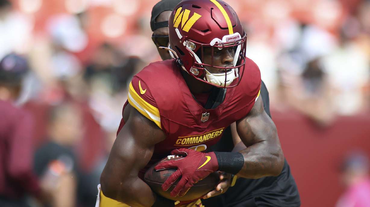 FILE - Washington Commanders running back Brian Robinson Jr. (8) runs with the ball before an NFL football game against the Cleveland Browns, Oct. 6, 2024, in Landover, Md.