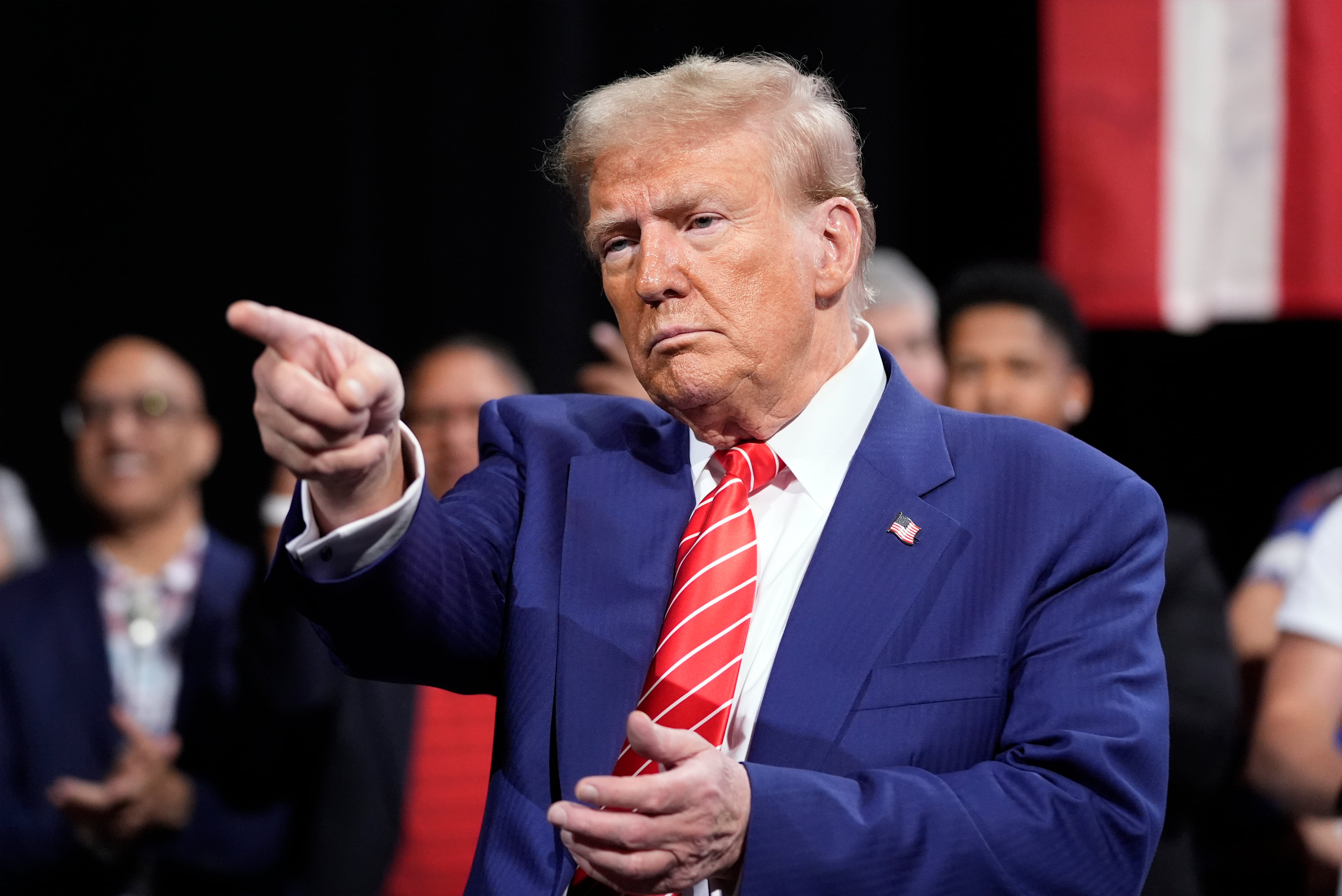 Republican presidential nominee former President Donald Trump gestures at a campaign event on Tuesday in Atlanta. Trump promised to end sanctuary cities for migrants, ban biological boys in girls sports, and cut energy bills in half, if reelected, during an all-female town hall on Fox News.